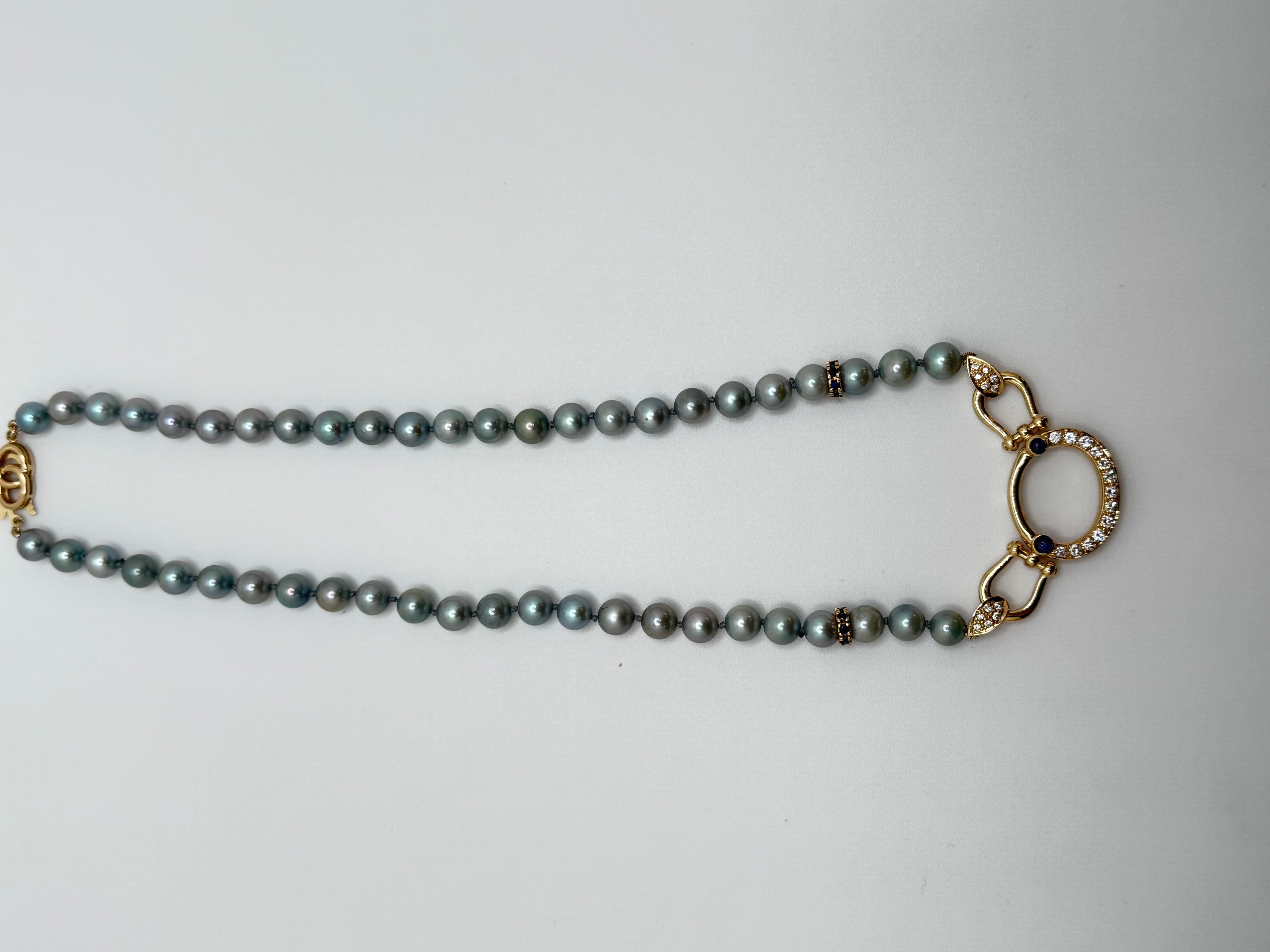 This elegant 14K yellow gold necklace is 17.5 inches long and features a graceful combination of freshwater dyed blue pearls, each measuring approximately 7.5mm. The strand includes a total of 48 pearls, beautifully accented by two round blue