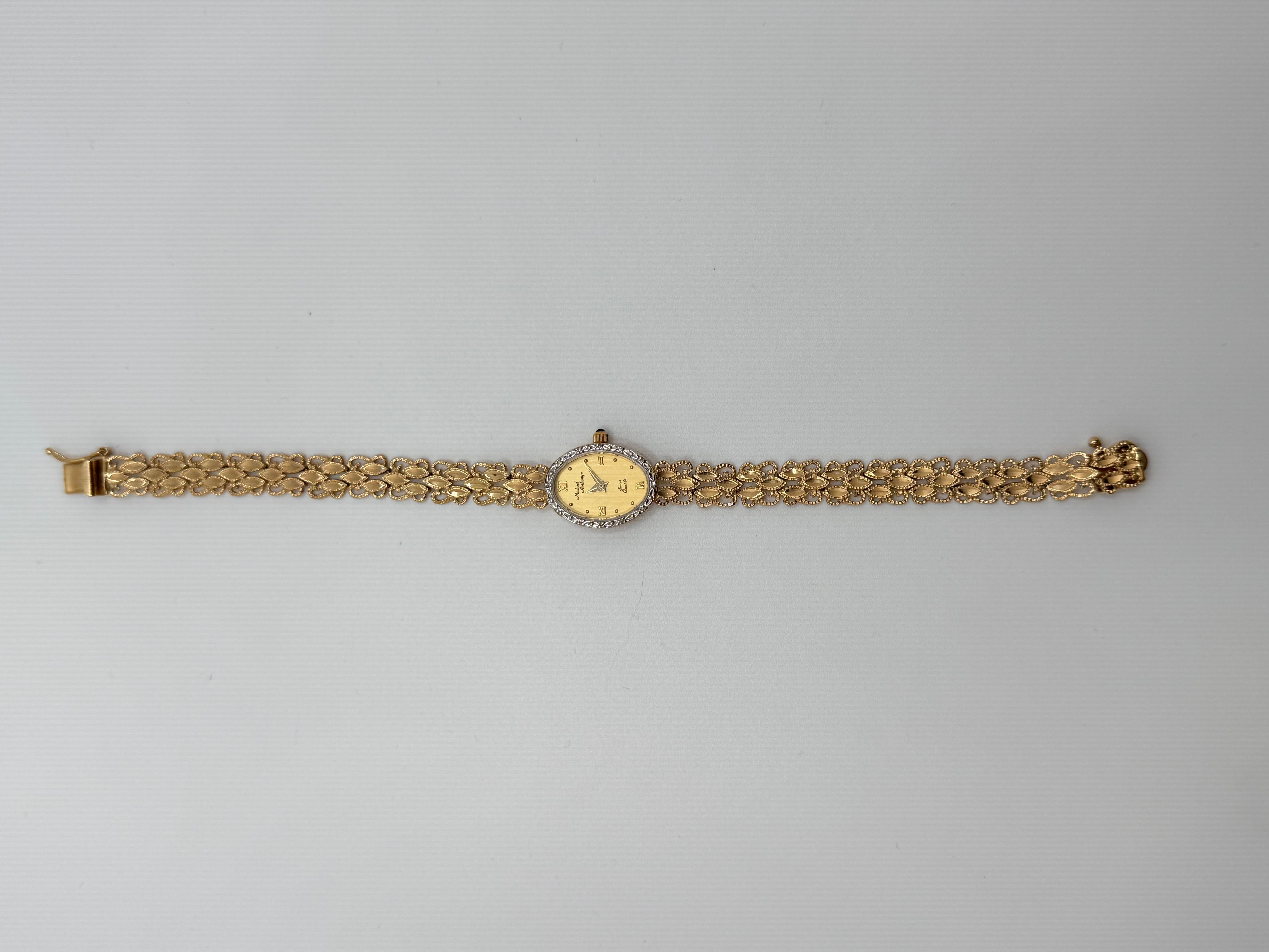 This elegant 14K yellow gold Michael Anthony Swiss quartz watch features twelve sparkling single-cut diamonds, prong-set around the dial for a refined touch. The watch showcases classic Roman numeral hour markers, blending timeless design with