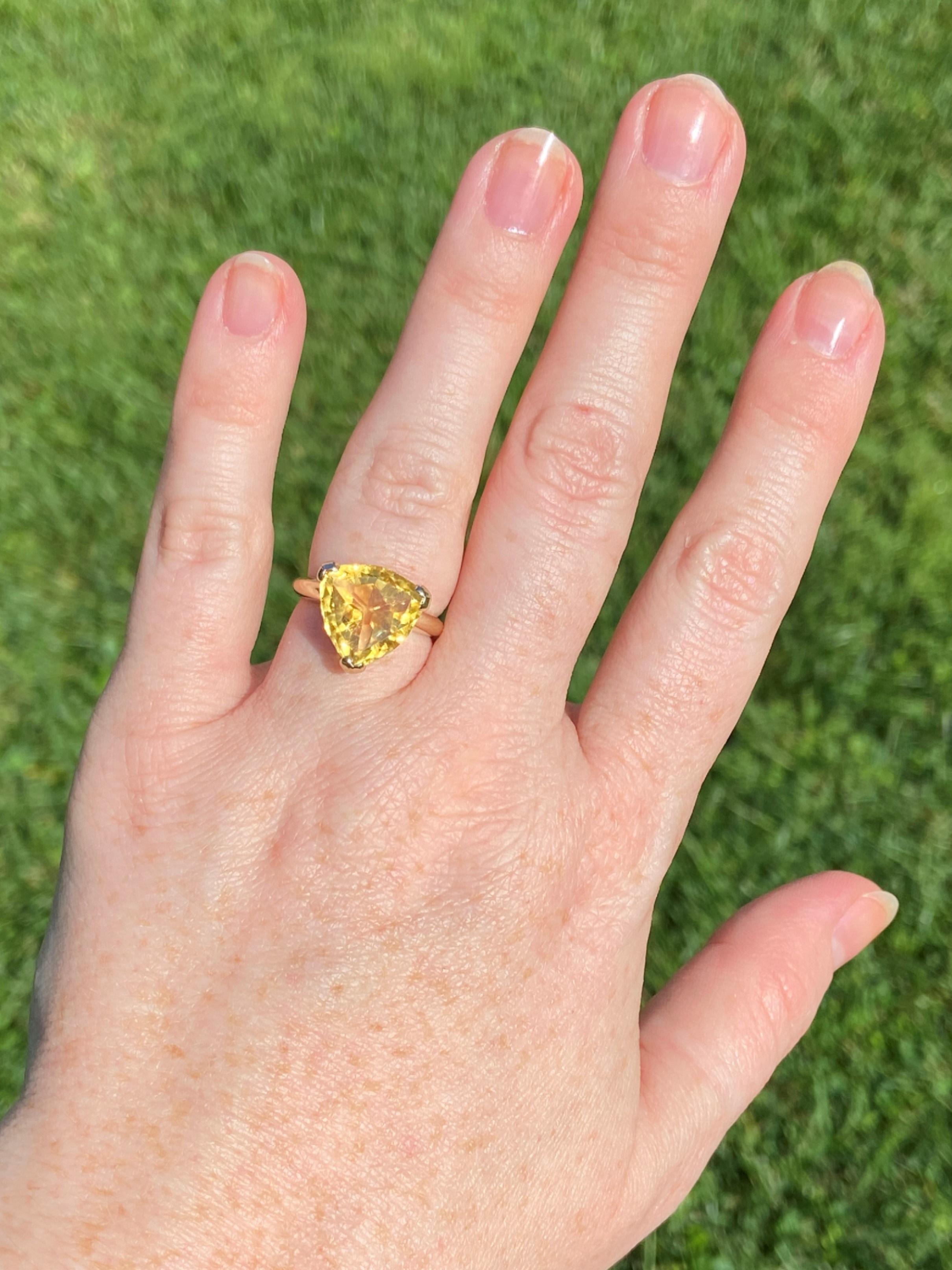 A large sundrop of a 5.45ct citrine sits at the center of this ring, and it is in a trillion cut, which is one we don't see very often. The setting is simple, which allows the stone and the cut to be showcased. 

The head of the ring measures 9/16