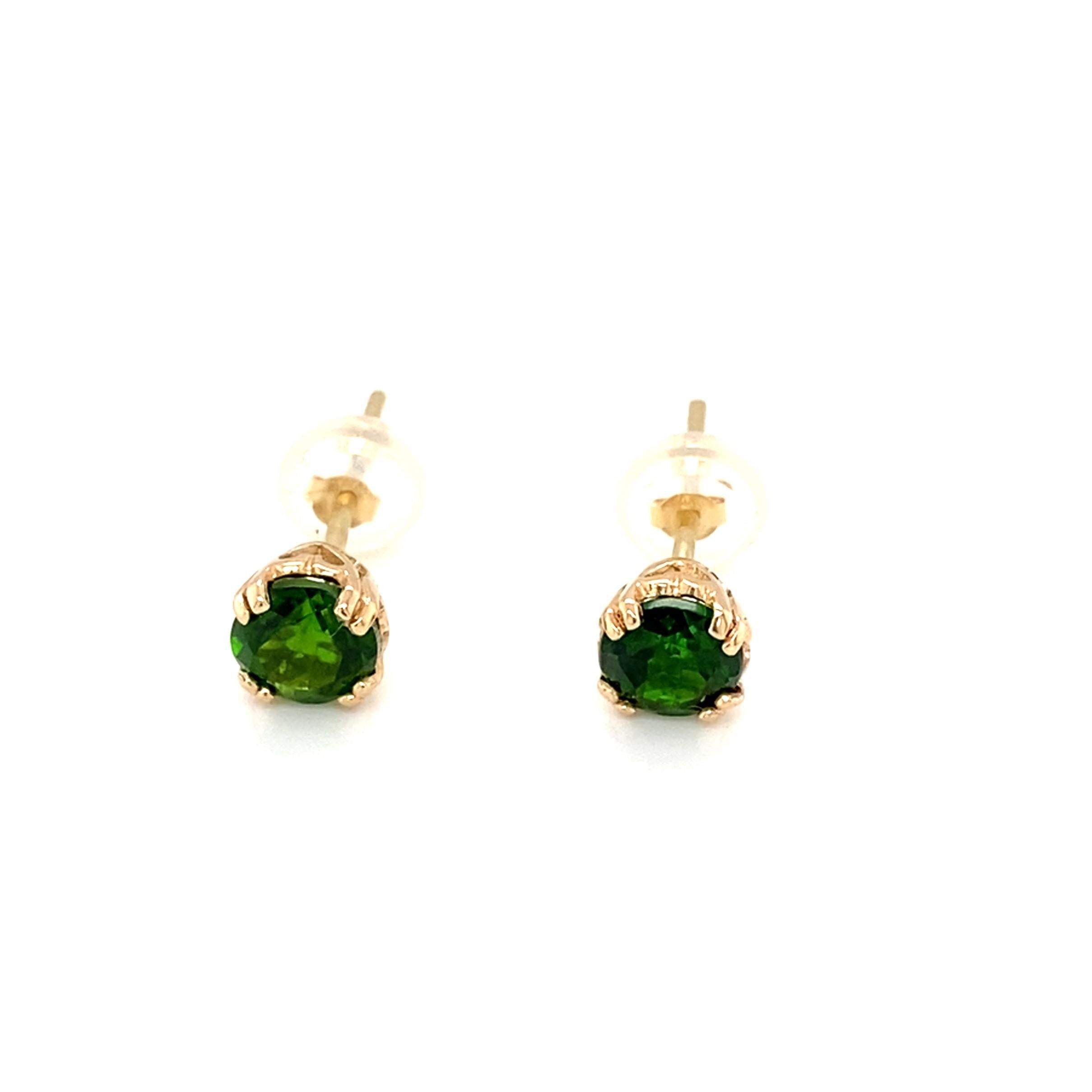These adorable 14 karat yellow gold stud earrings have two great features: 1) GLORIOUSLY colored 5mm green diopsides and 2) adorable heart detailing on the settings. 

The diopside is such a rich green color that they look like the finest emeralds.