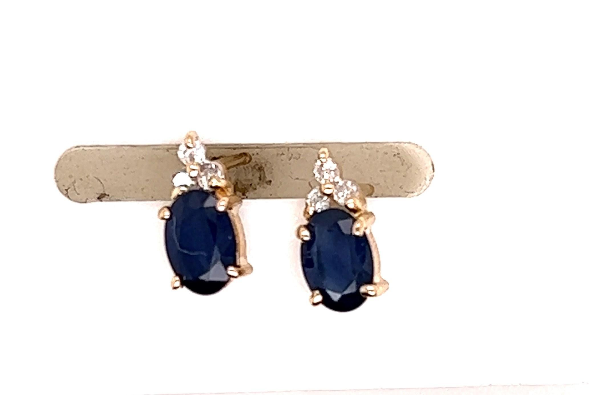 14kt yellow gold stud earrings with oval sapphires weighing approximately 1.10 carats and three diamonds at the top of each sapphire weighing approximately .18 carats. The diamonds are H-I color and SI1-I1 Clarity. 

the earrings measure 5/16 inches