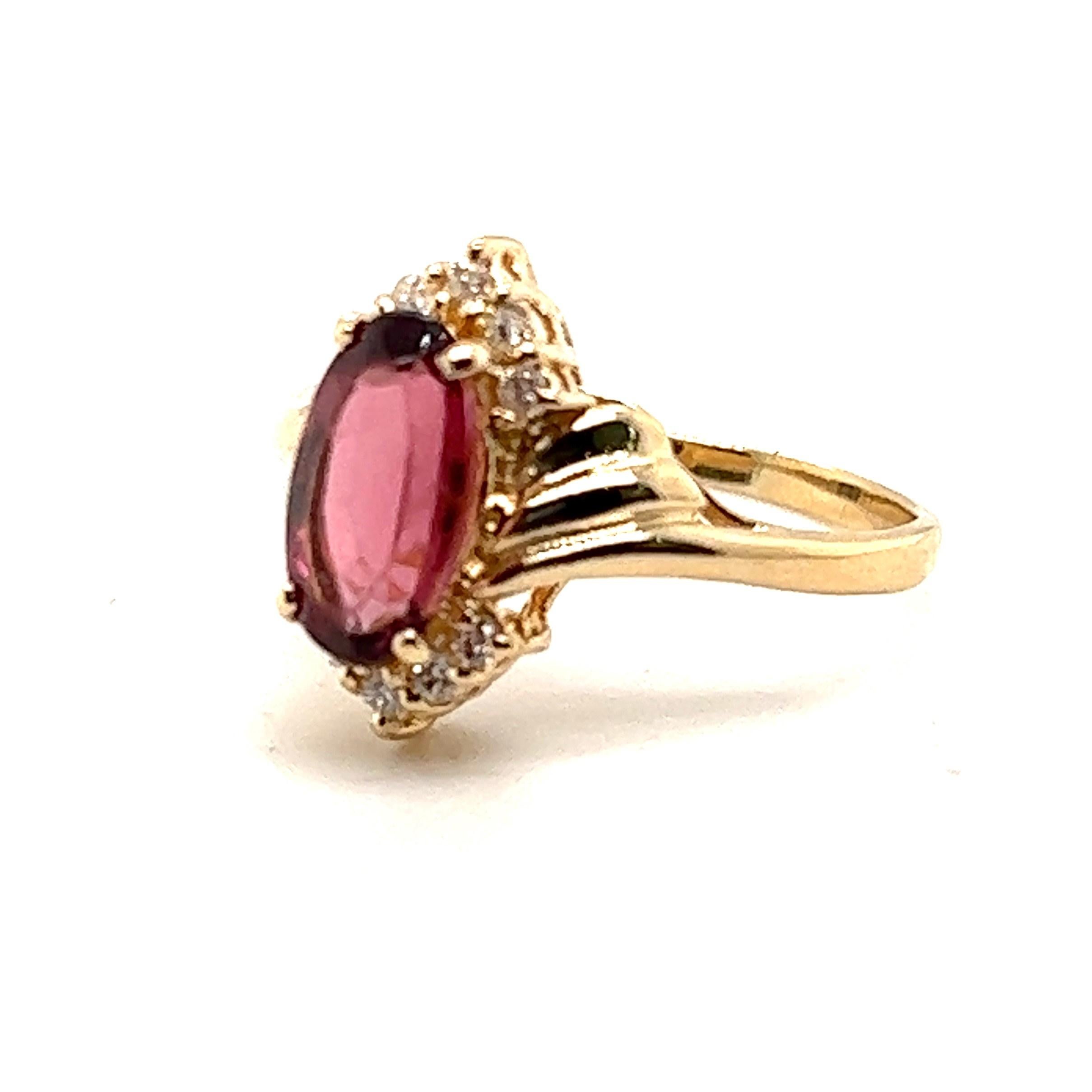 Fit for a princess. 

14K yellow gold 1.67ct  Pink Tourmaline ring with .10 carats of  H-I/I1-I2 diamonds. 

The ring is a finger size 7.50 and measures 5.8 inch high at the top by about .25 inch wide. 