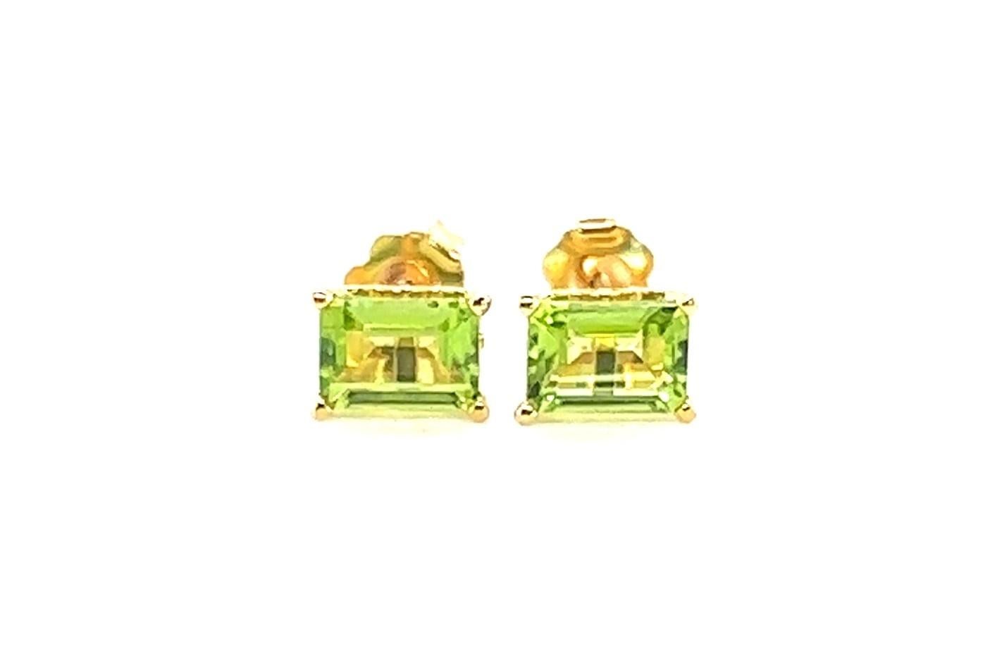 14kt yellow gold stud earrings containing approximately 2.00 carats of rectangular cut peridot. The peridot is a gorgeous lime green color. It's the color of new leaves in the spring. 

The earrings measure 5/16inch long. The settings have a lovely