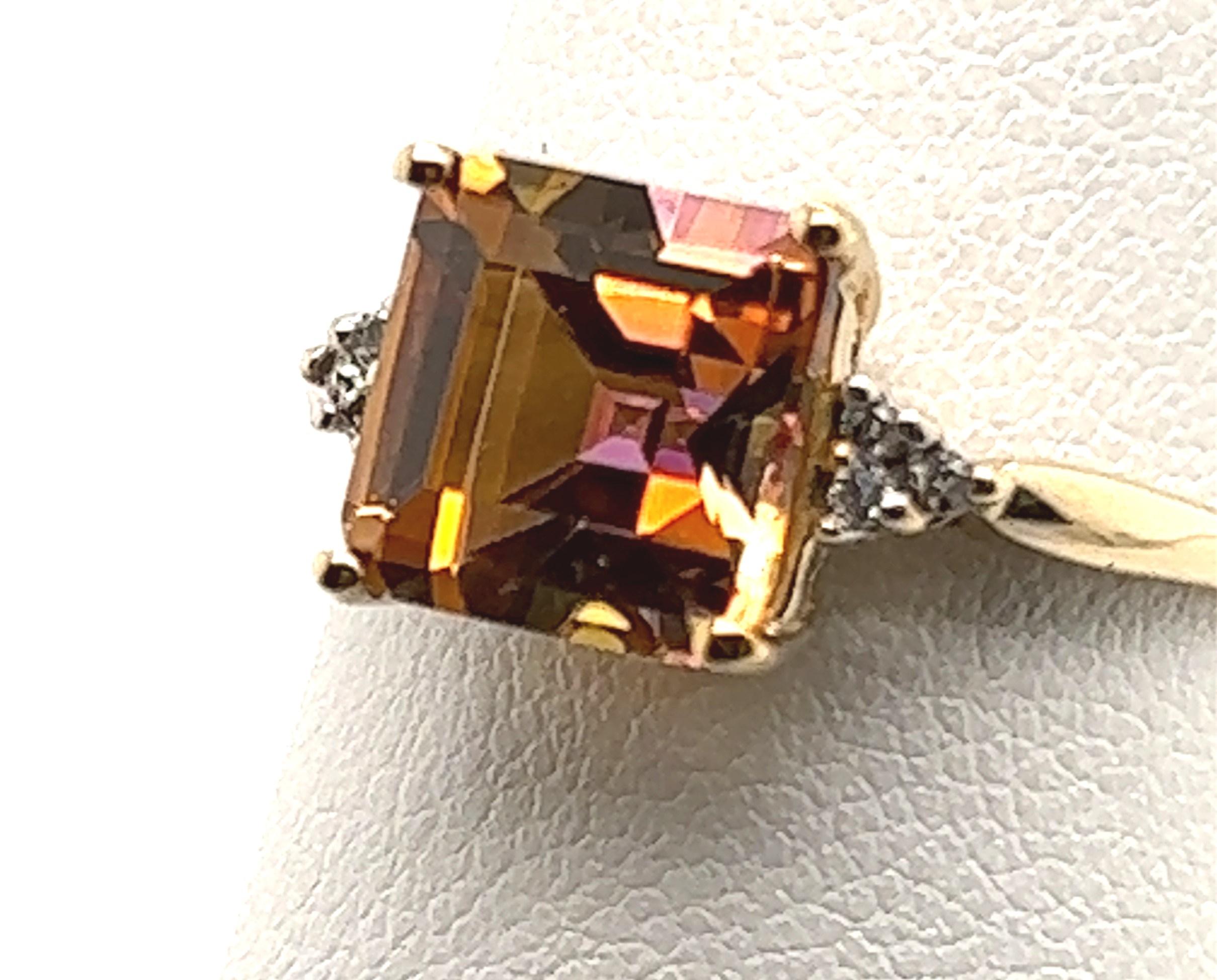 Unique mystic topaz with pink and orange colors. Most mystic orange were blue and green, this one is pink and orange but is indeed topaz and made with the same process as the blue-green mystic topaz. The ring also contains approximately .06 carats