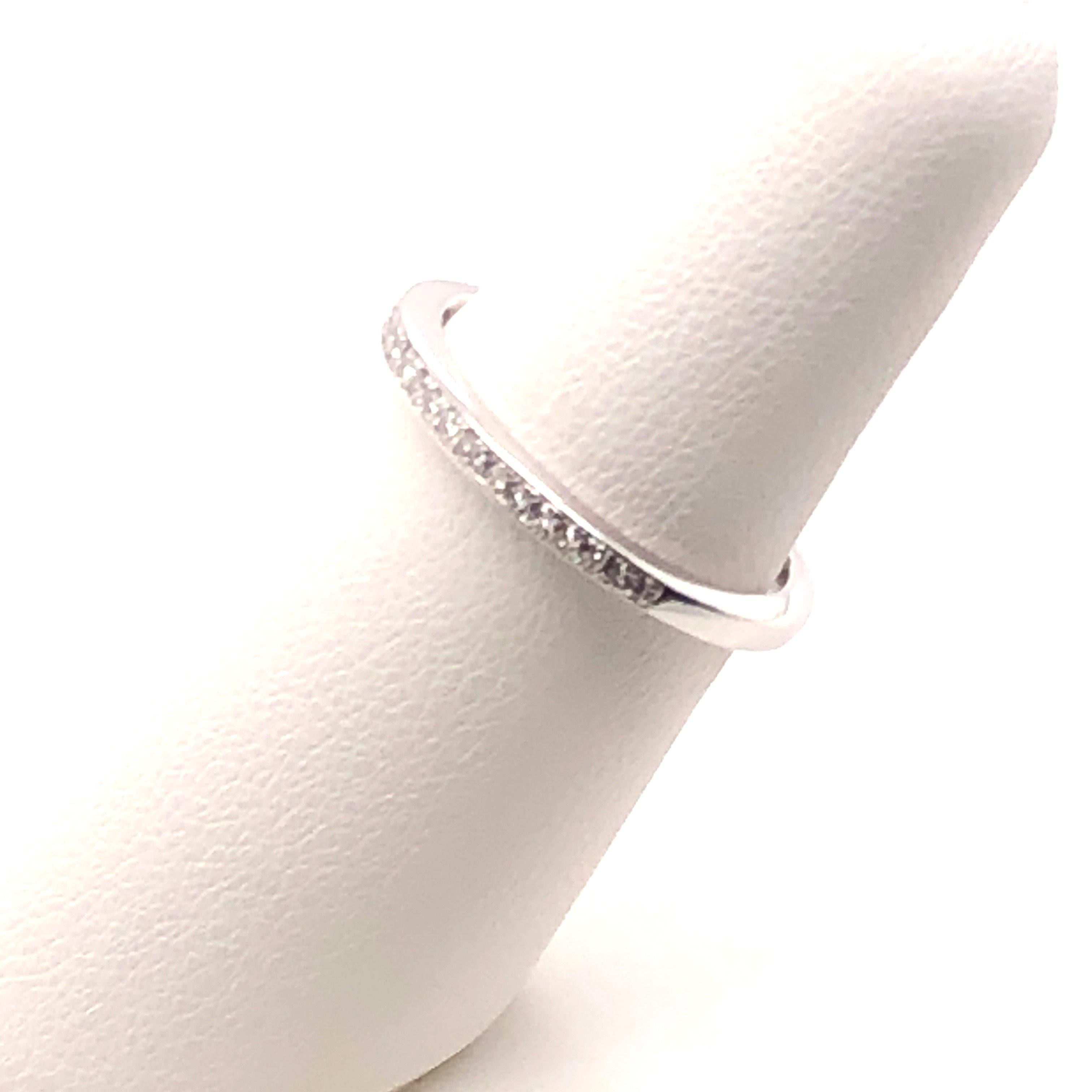 Sleek and sparkly 14kt white gold band with approximately .38 carats to H-I color and SI1-SI2 diamonds. The ring is 2.35mm x 1.75mm and a finger size 6. This band can be sized up or down approximately 2 sizes. This is a great stackable ring!