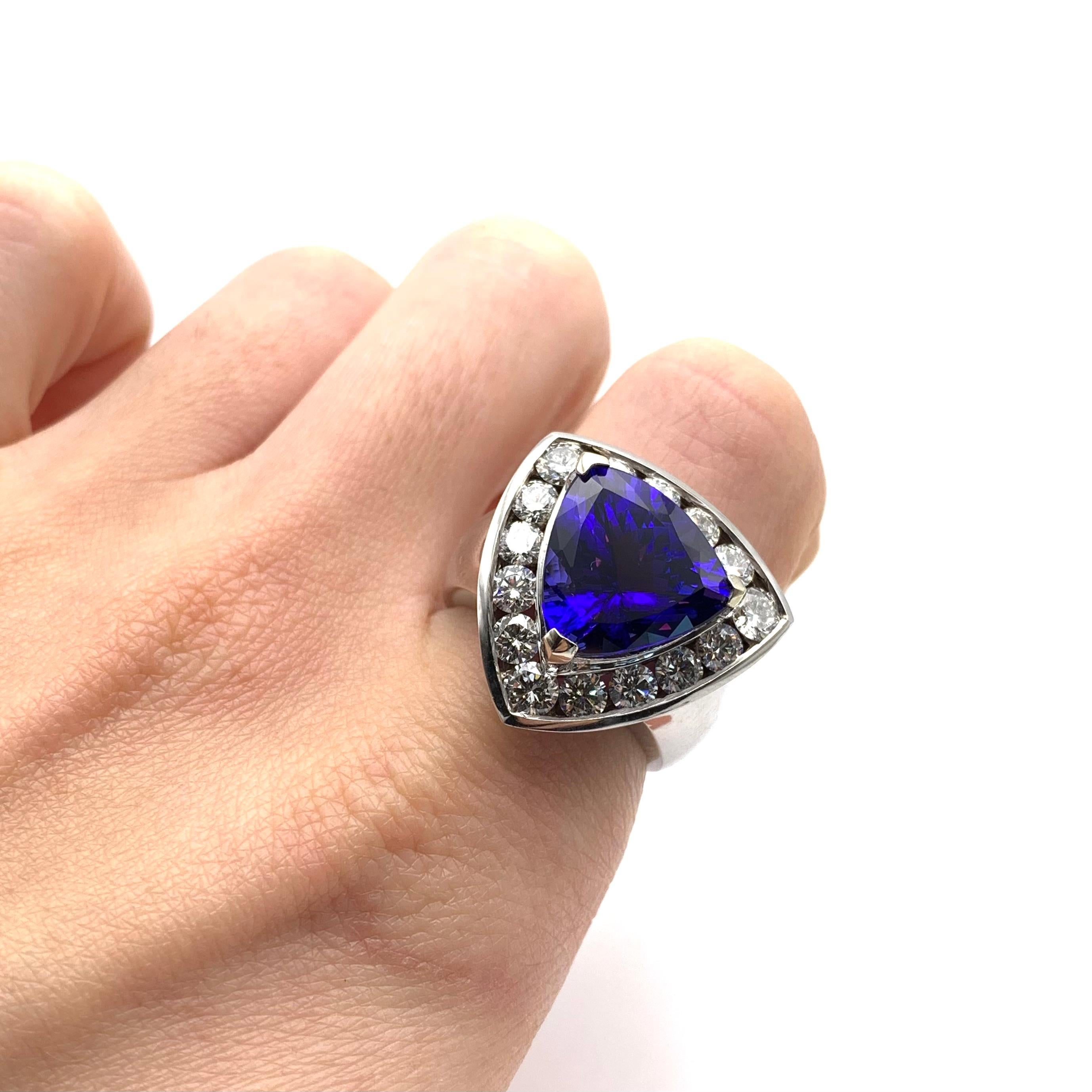 This fabulous cocktail ring is a part of our estate collection. It is set in 14-karat white gold and is prong-set with one trillion-cut tanzanite measuring 7.63 carats. The stone is cut well and has a wonderful tri-color play with rich purples,