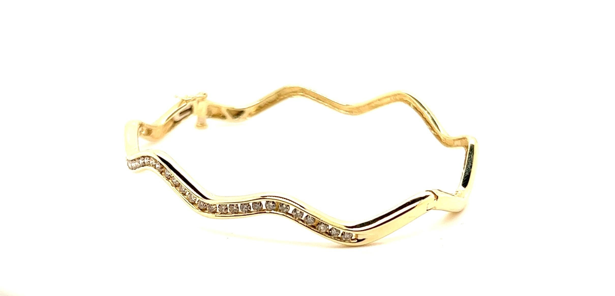 Classic with a twist! Take a classic bangle channel set bangle and make it a zig-zag  pattern. Now you can have something else to stack with your other bangles or just something else no one else will have!

The bangle is 14kt yellow gold with