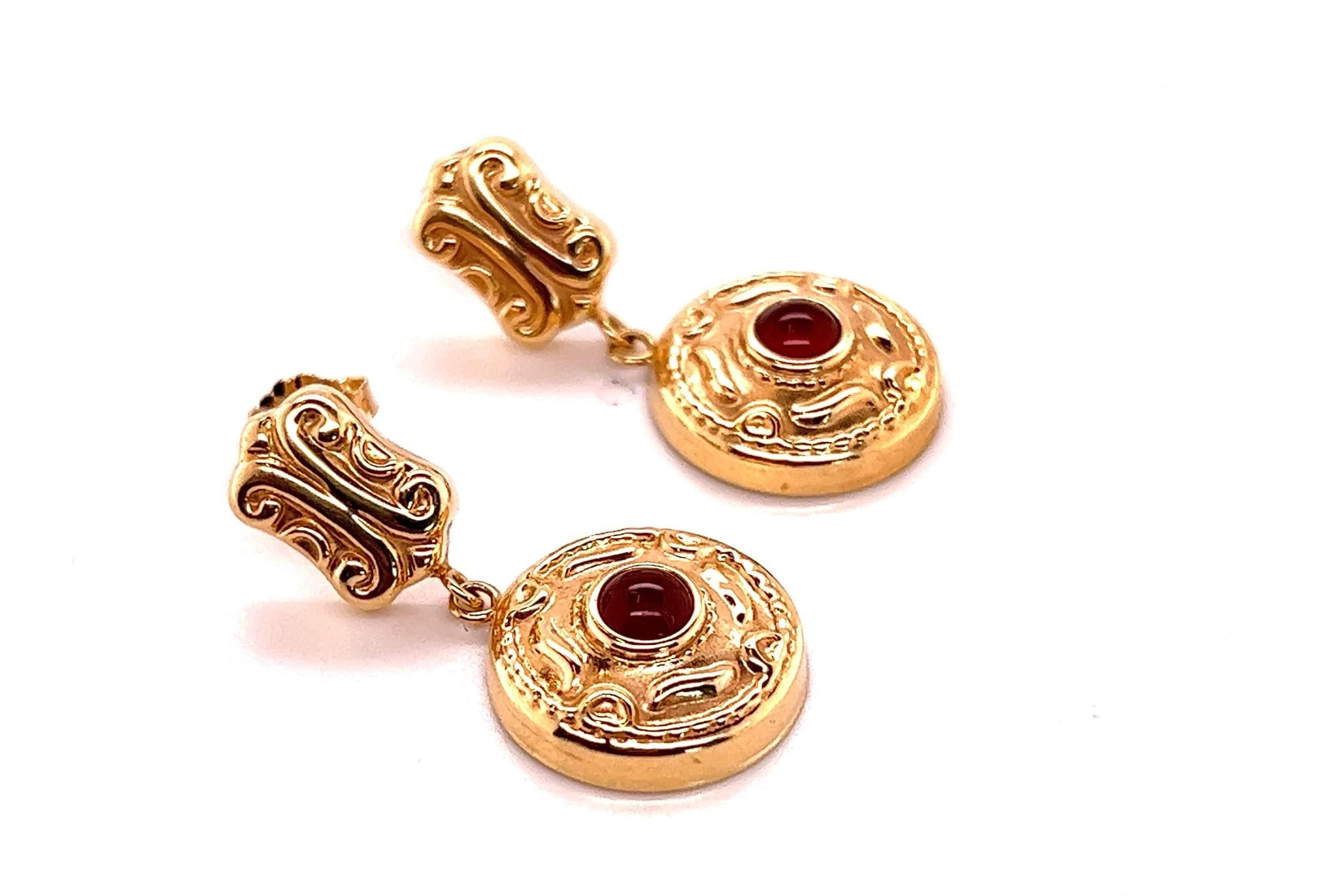 Add some flare to your earring game with these attractive ruby cabochon earrings. 

The earrings are lightweight even though they're 1.25 inches long! They won't hurt your ear lobes from heavy weight and they won't pull your piercing down to show