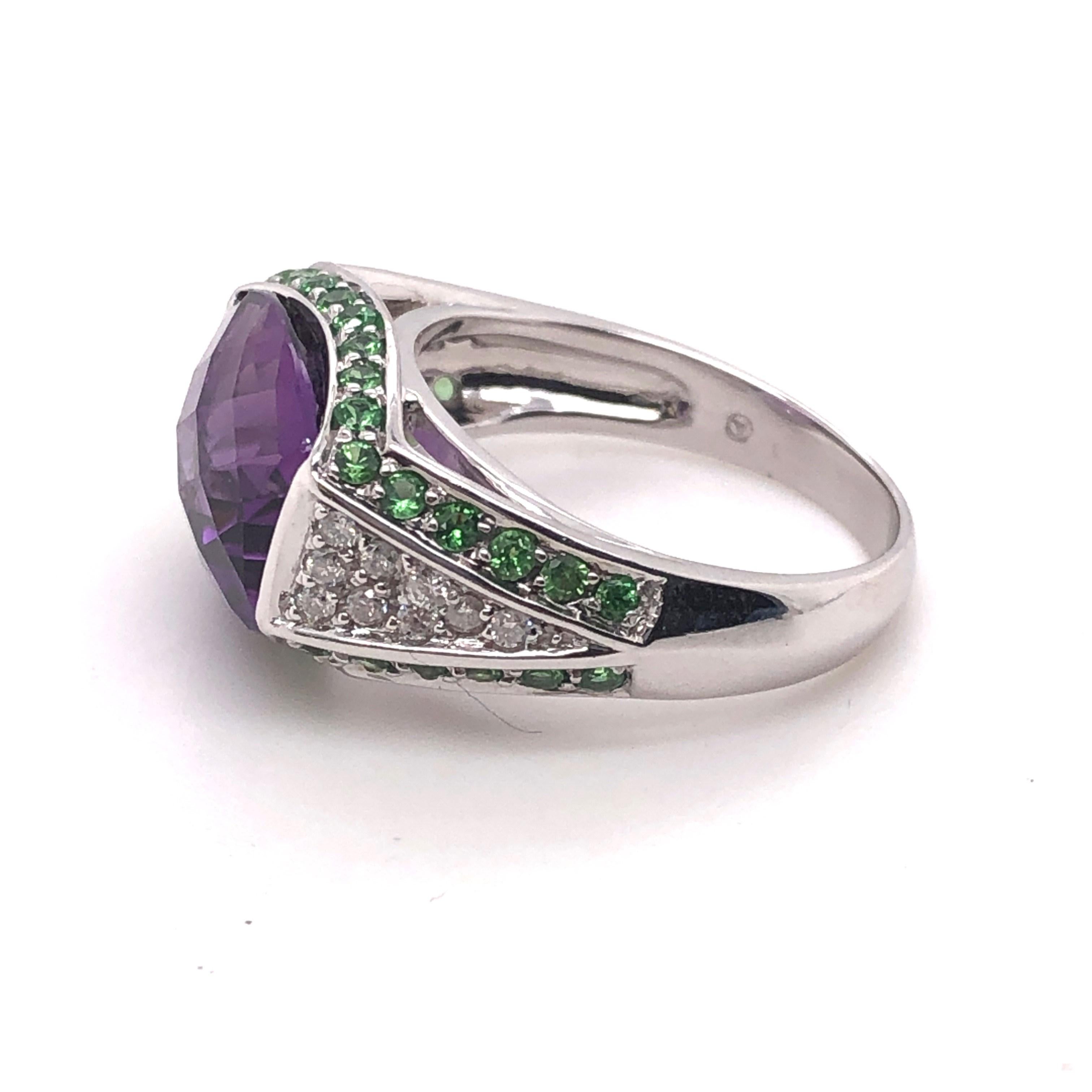 14kt white gold approximately 5.00ct antique cushion cut Amethyst with approximately .38tcw Tsavorites and .09tcw Diamond ring. This ring is a finger size 8 and can be resized. 