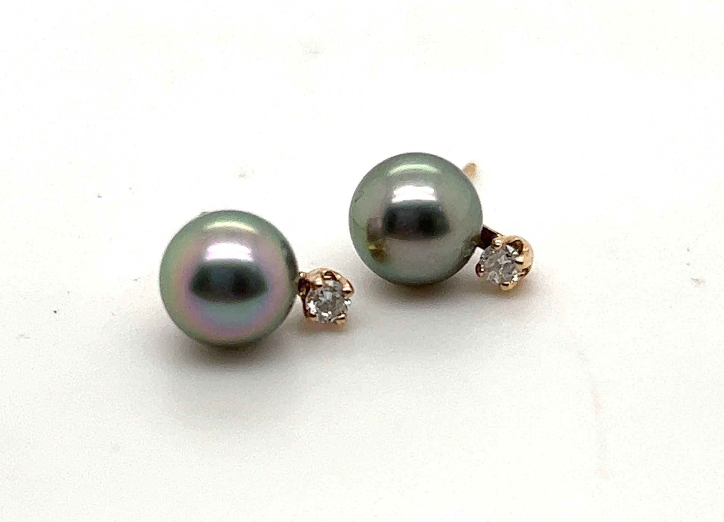 14kt yellow gold stud earrings with 7mm round black pearls and approximately .06 carats of H-I/I1-I2 diamonds. 

The earrings measure 3/8 inch long. 