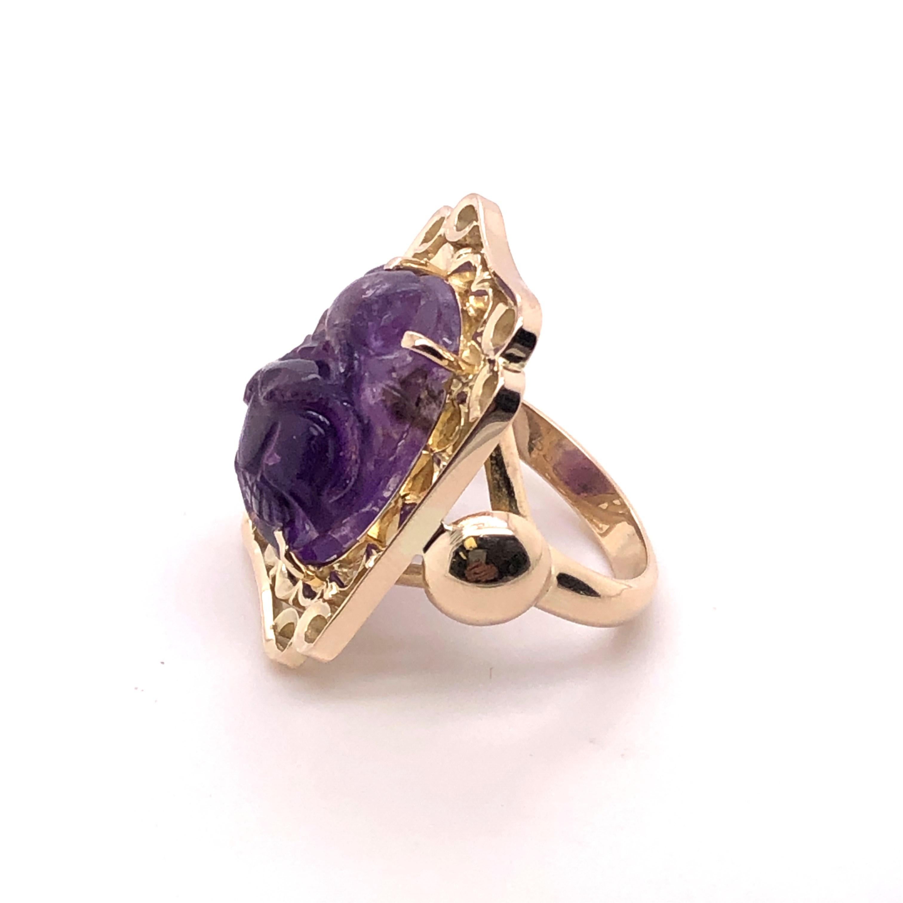 14kt yellow gold approximately 14.50 carat carved amethyst ring. The amethyst contains a floral carving and shows the variations of color from the natural amethyst. This is a statement ring! It was made in the 1960's when 