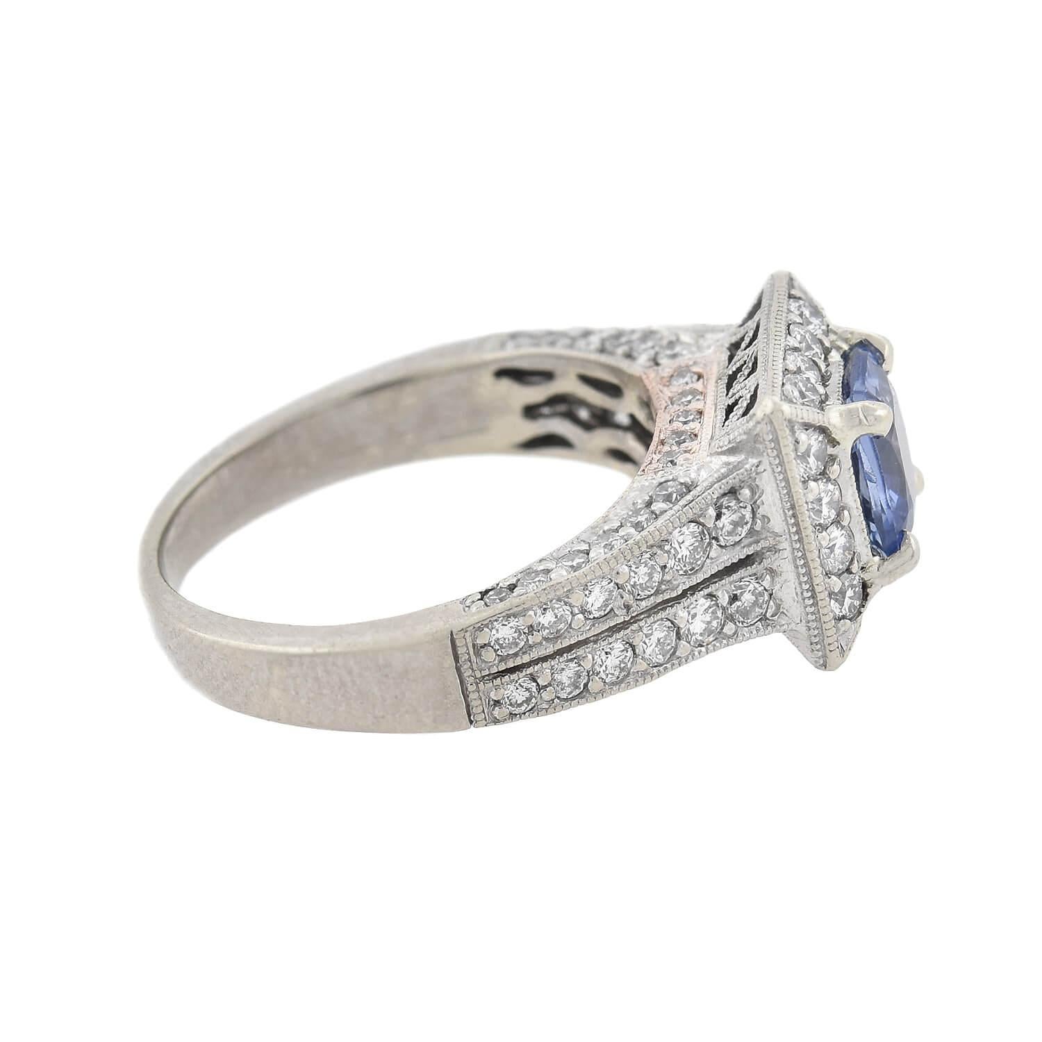 A lovely sapphire and diamond ring! Crafted in 14kt white gold, this beautiful piece features a Cushion Cut sapphire resting within a square diamond halo. The sapphire emits a lovely cornflower blue hue and has a total approximate weight of 0.90ctw.