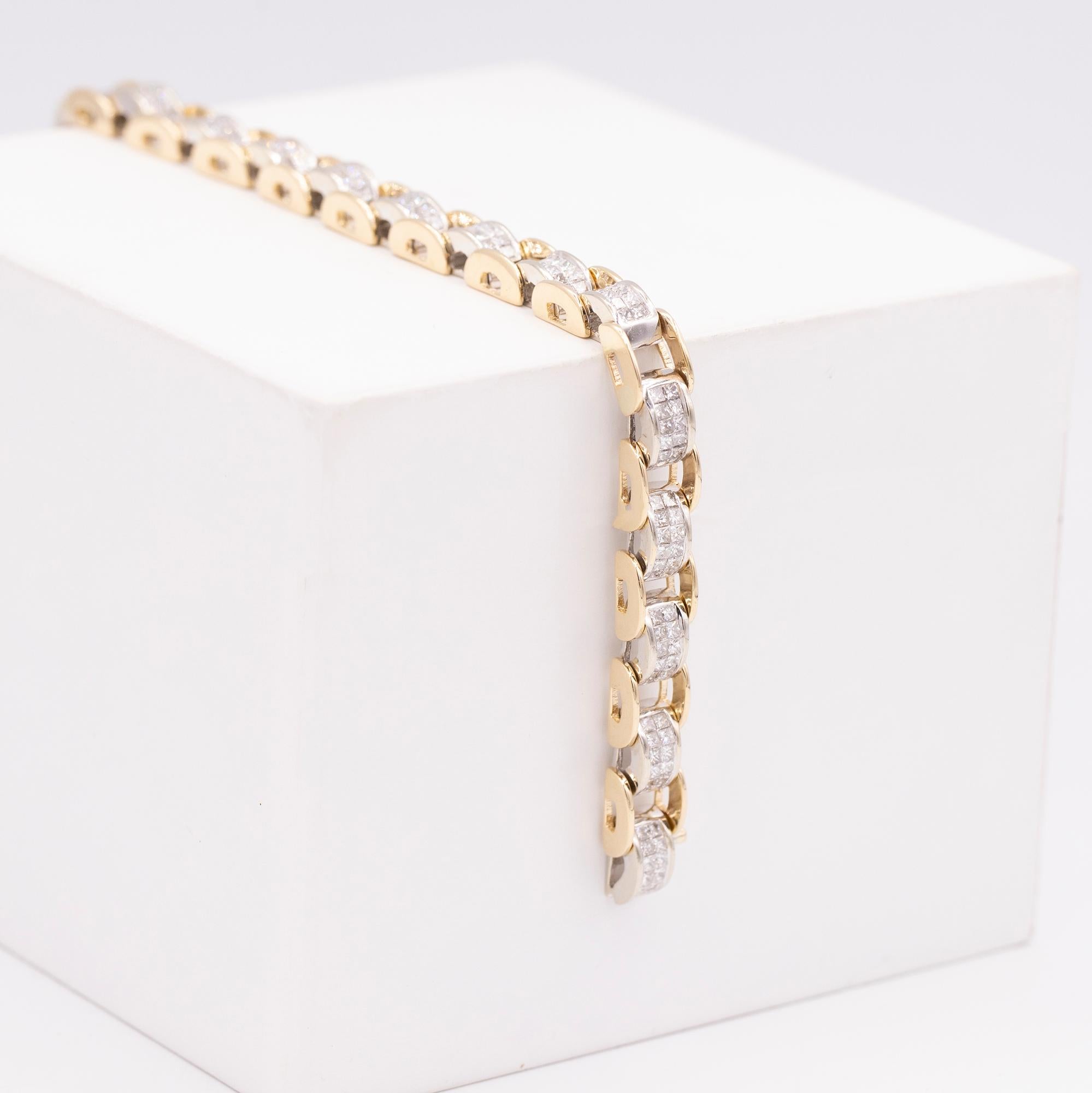 14 karat yellow gold & white gold diamond bracelet with 192 princess cut diamonds. The bracelet measures at 7.25