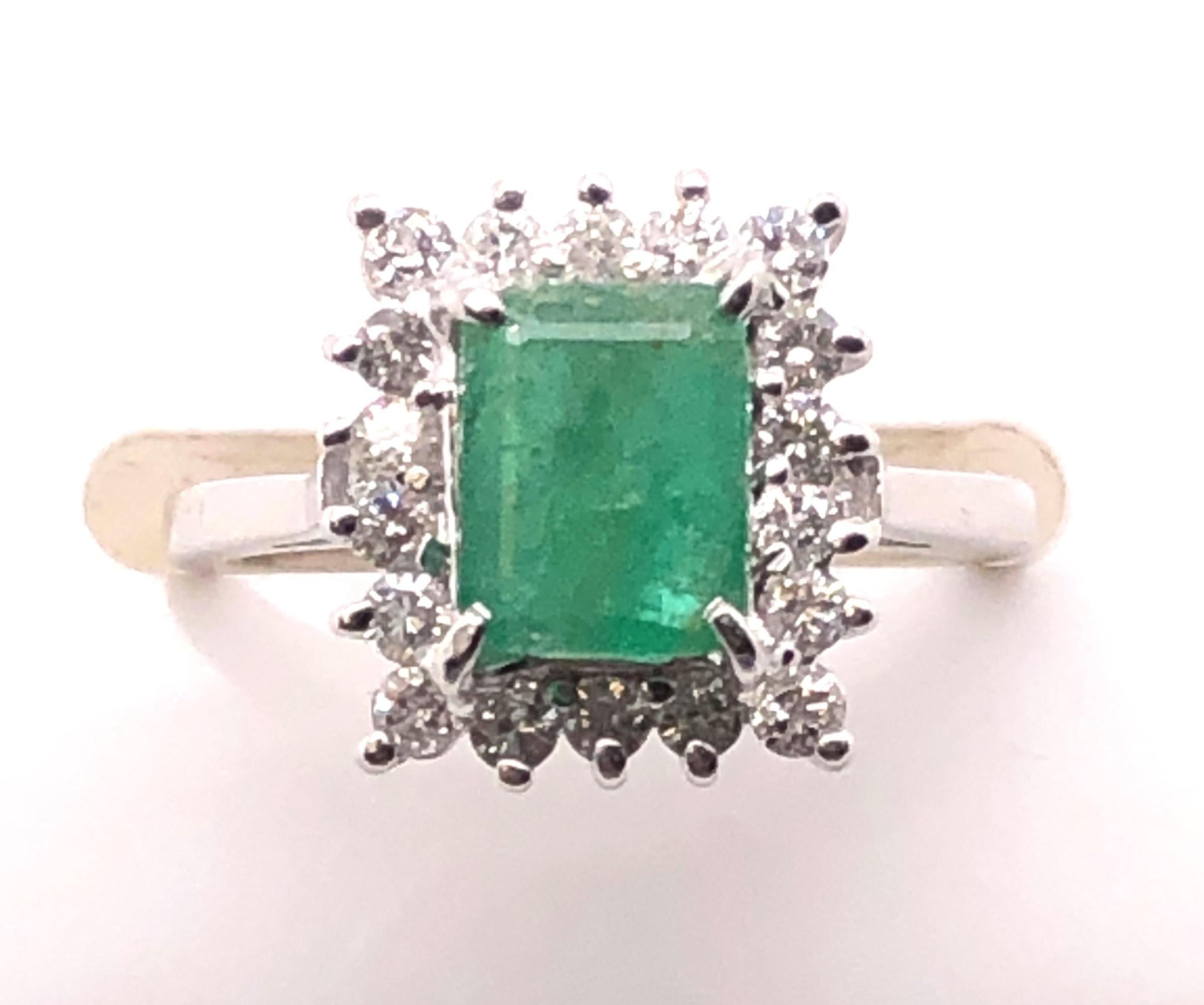 14kt white gold ring with emerald cut 1.42ct Emerald and .54tcw H-I/ I1-I1 Diamond Halo. 

The ring measures just over .25 inches vertically and .50 inch high. The ring is a finger size 6.50 and can be resized. 

This ring sells for $1295 in our