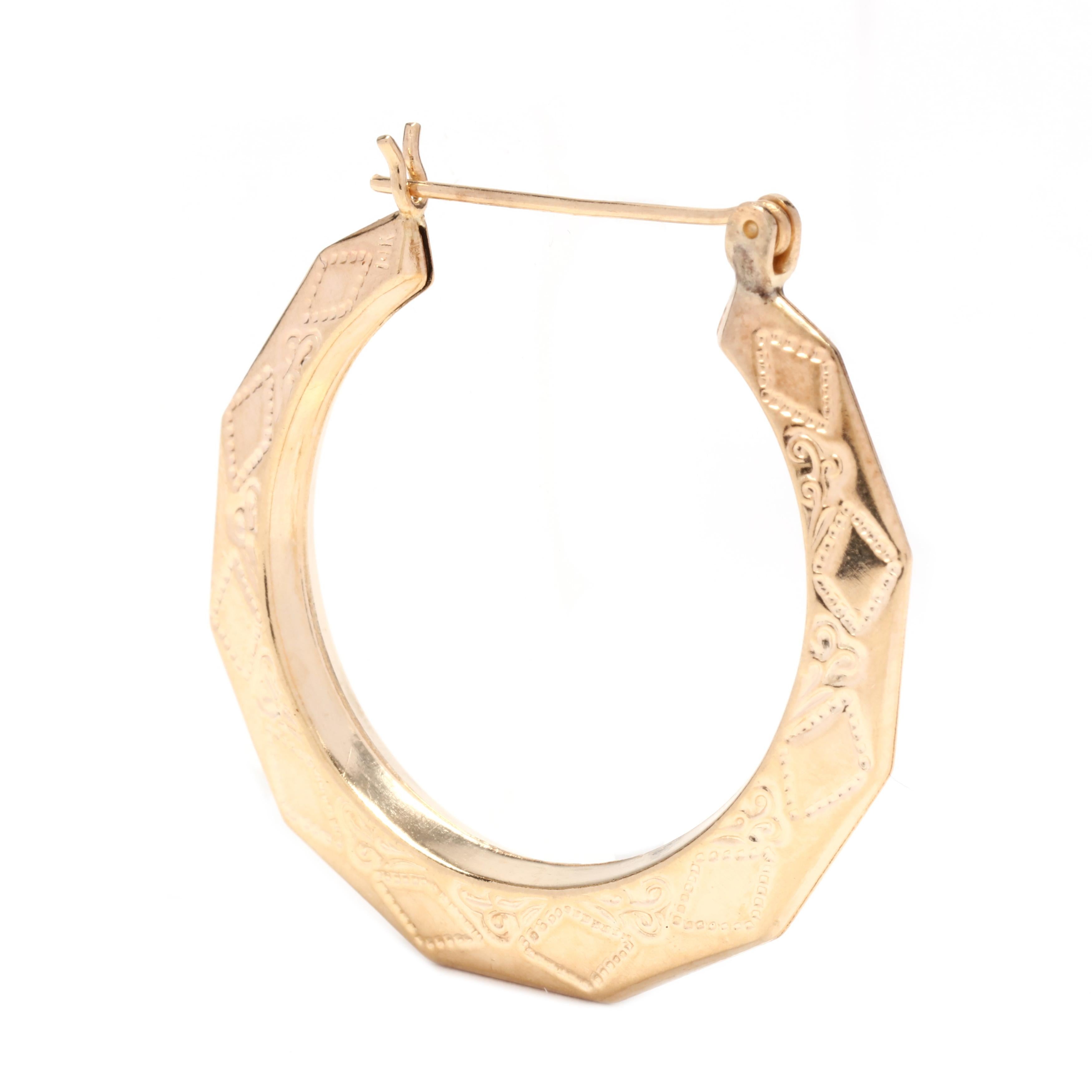 A pair of vintage 14 karat yellow gold geometric engraved hoop earrings. These earrings feature a tapered, faceted design with a geometric engraved design and snap posts.



Length: 1.25 in.



Weight: 2.8 dwts.