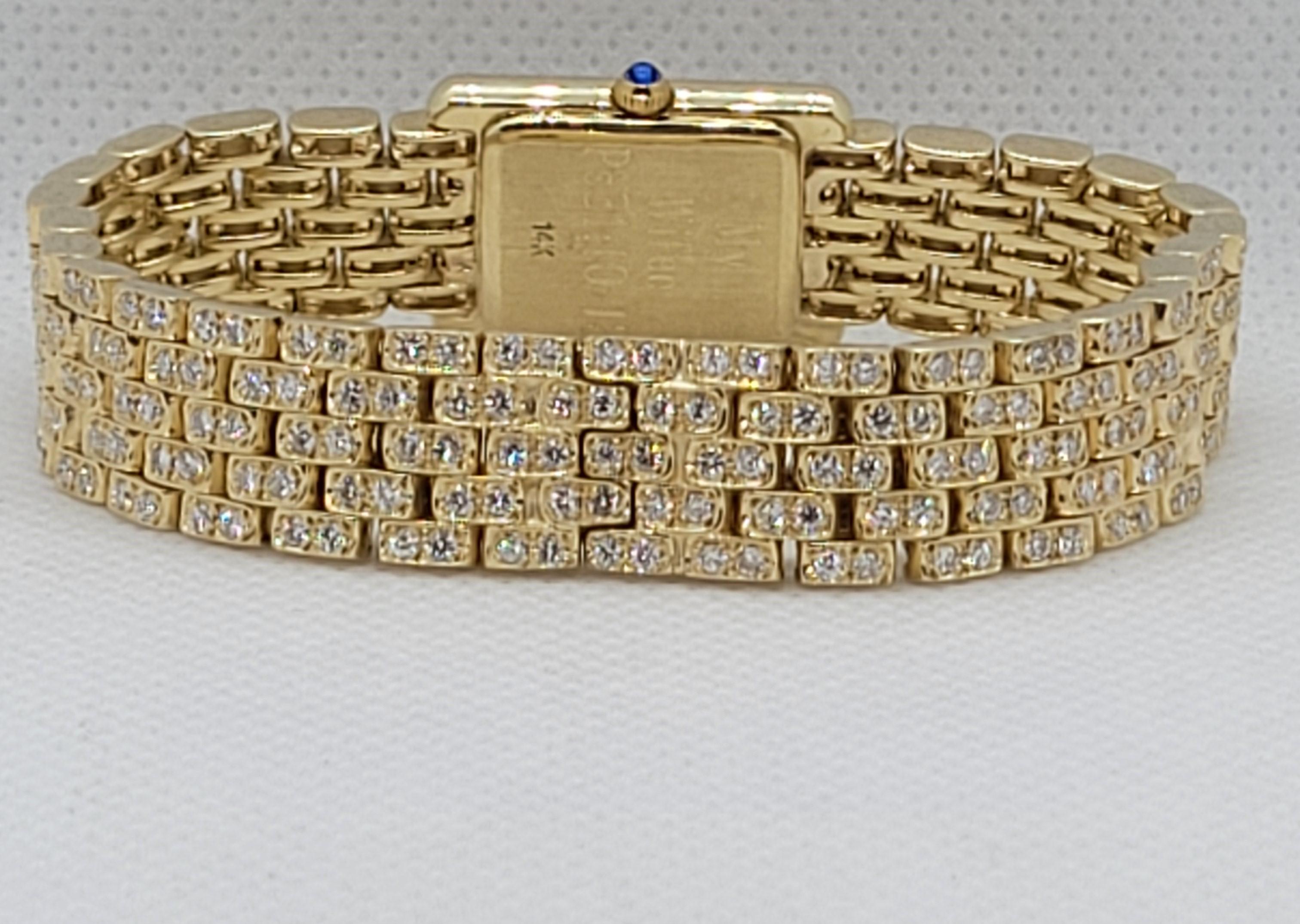 Beautiful 14kt yellow gold diamond Geneve tank with 280 diamonds of approximately 4.20cttw. The diamonds are G/H in color and VS/SI in clarity. The tank watch has a rectangular face that is 17mm x 23mm in size, and 5.15mm thick with a sapphire