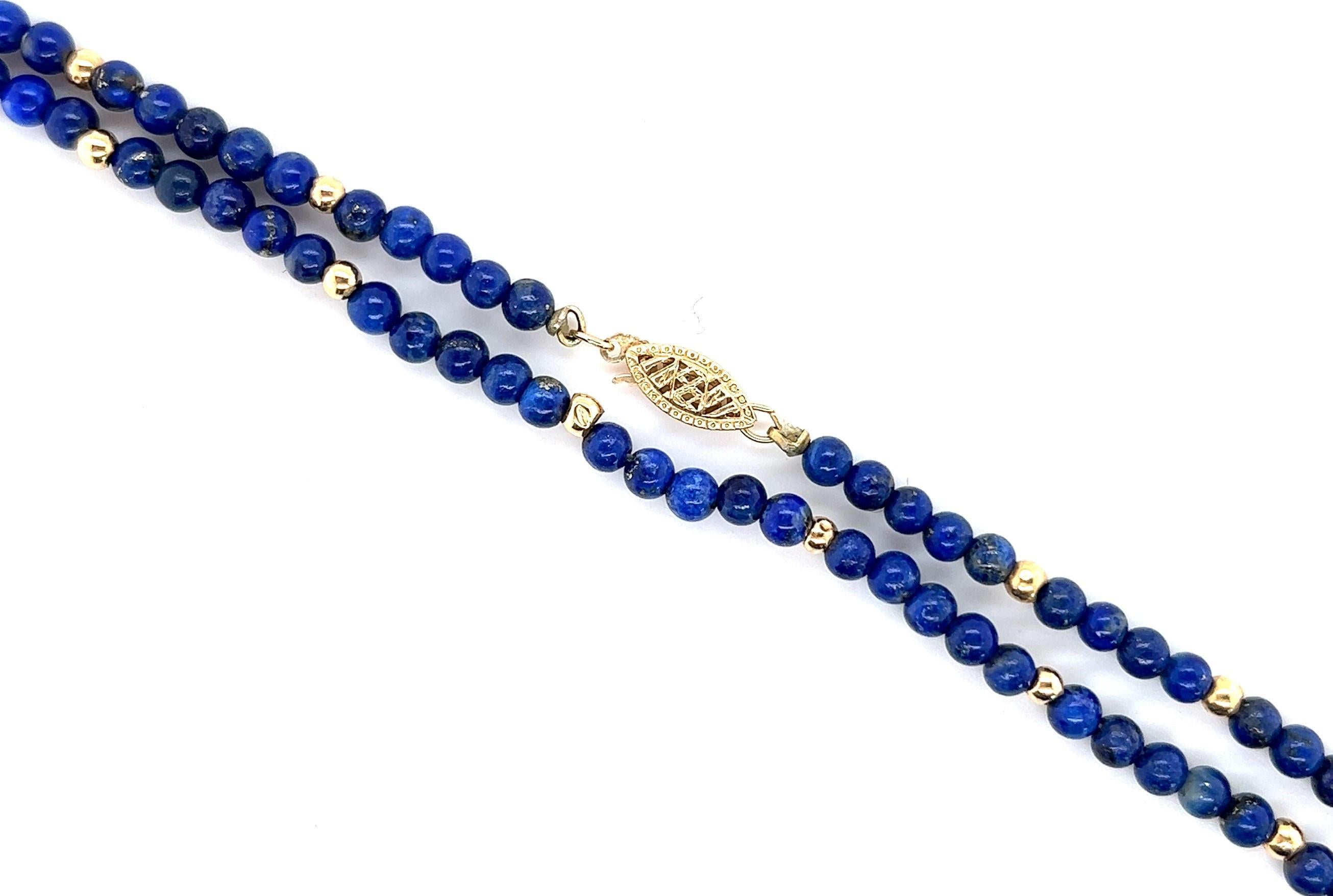 Wonderful quality Lapis Lazuli necklace containing 4.50mm round lapis and 3.15mm 14kt yellow gold beads. 

The necklace is 26 inches long.

Wear it as one long strand of beads or double it if your necklace accommodates that length. This can be worn