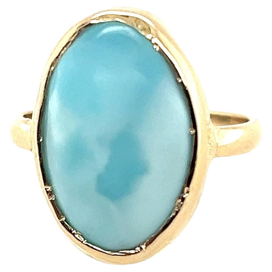 It's unusual to see larimar hand bezel set in 14 karat yellow gold. The cabochon larimar measures 17.36mm x 11.48mm 6.22mm. The ring measures 13/16 inch long x .50 inch wide bezel to bezel and the shank measures 2.34mm x 1.16mm to 2.25mm x 1.20mm.