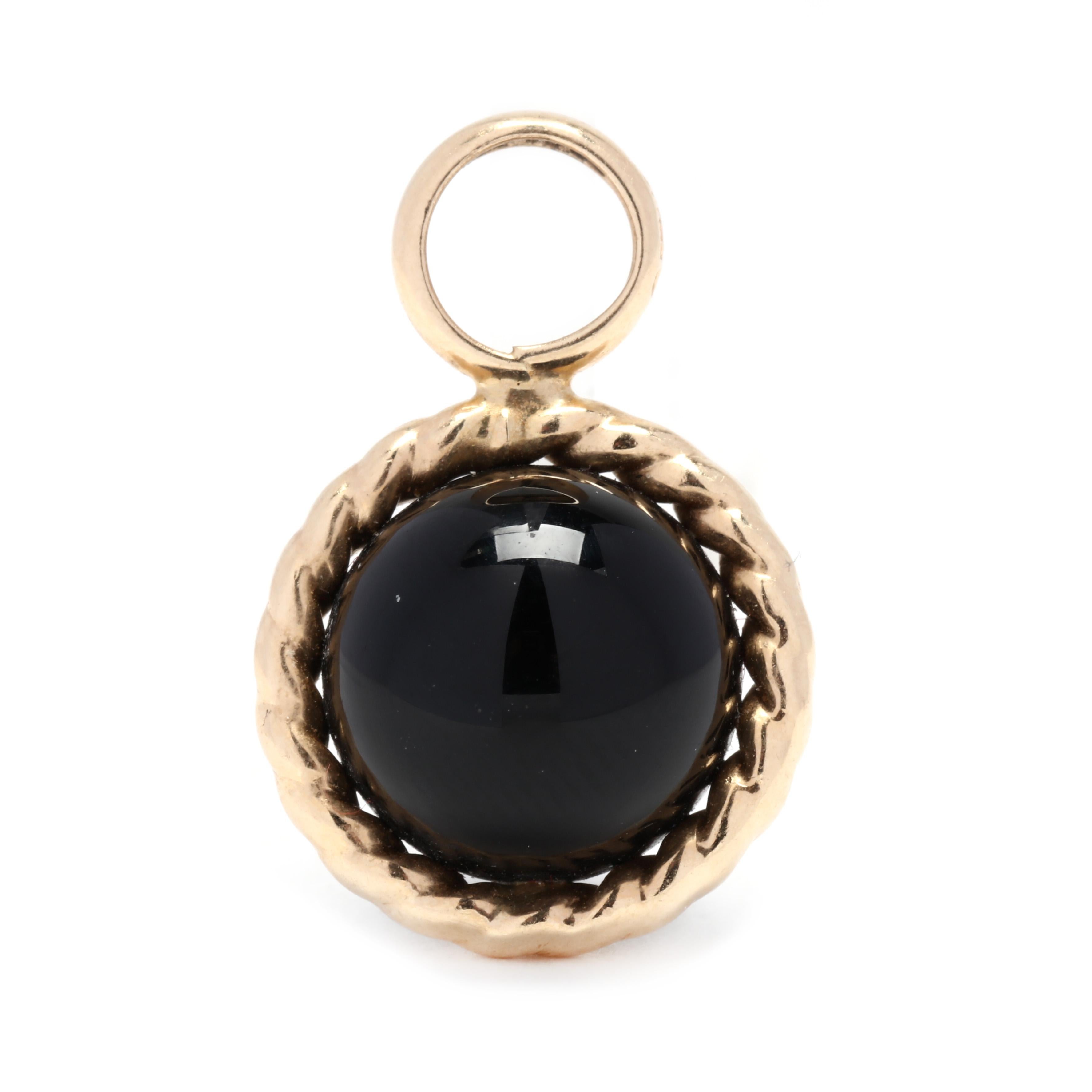 A 14 karat yellow gold black onyx bead charm. This charm features a round black onyx bead with a rope border and a round ring at the top to string on a chain.



Length: 3/4 in.



Width: 1/2 in.



Weight: 1.05 dwts.