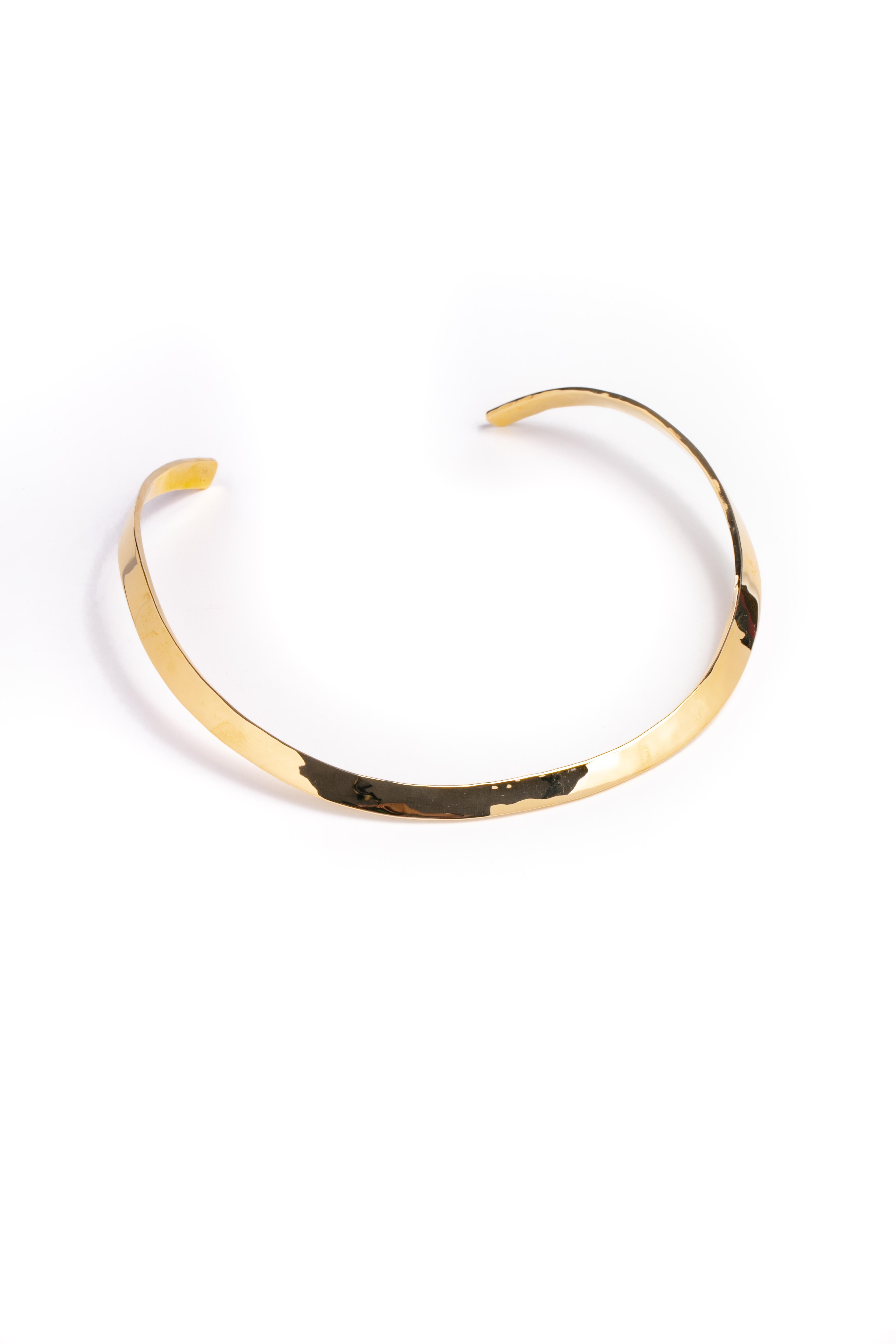 A ribbon of 14k yellow gold is hand-fashioned into a sophisticated, comfortable collar. With The Golden Bear's signature Tiny Bear resting on the back edge. 1/4