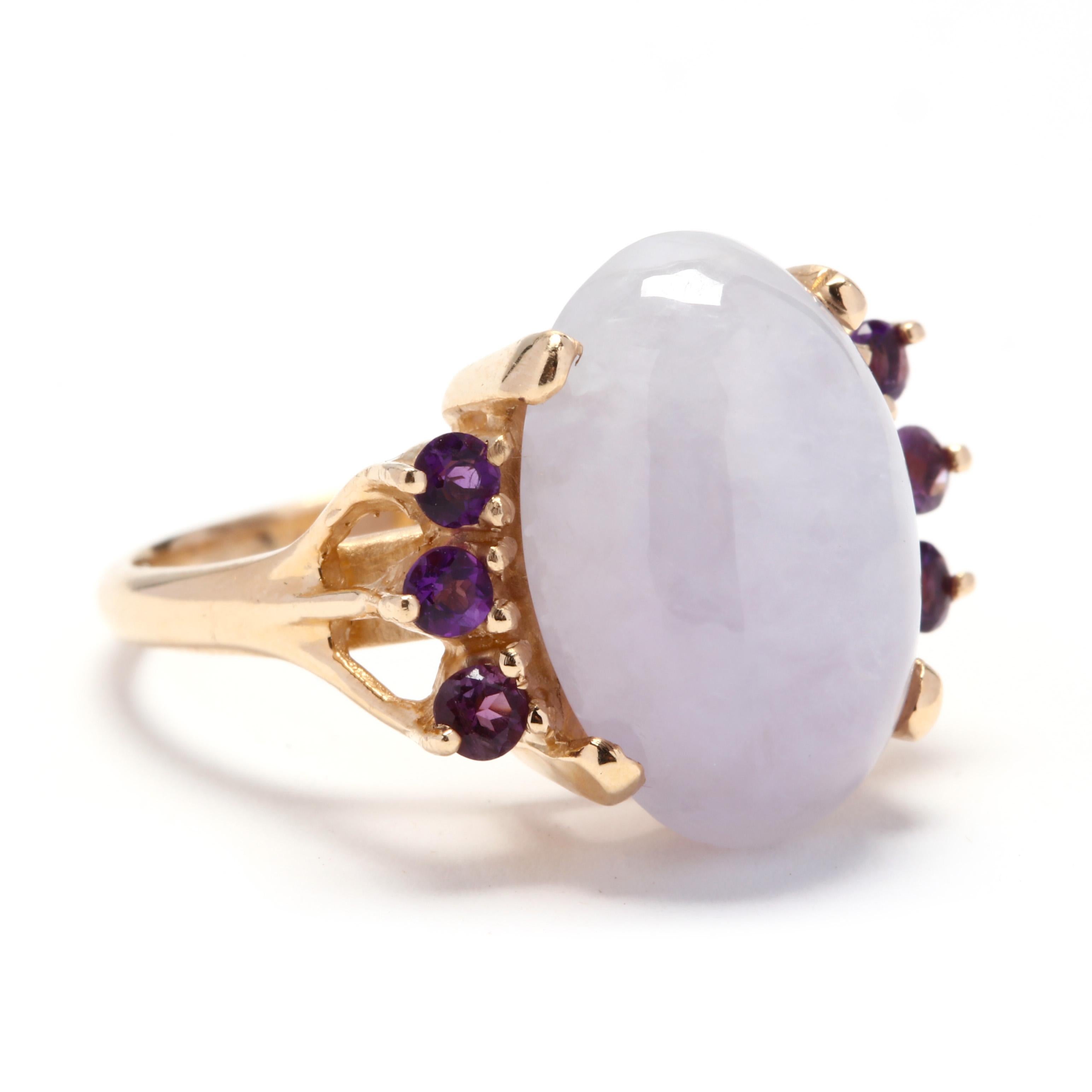 A 14 karat yellow gold, lavender jade, and amethyst cocktail ring. Centered on a prong set, oval cabochon lavender jade stone weighing approximately 11.8 carats with three round cut amethysts on either side and a split shank. A ring fit for a