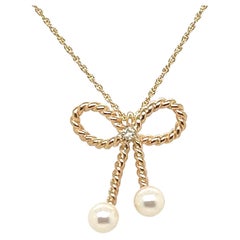 14kt Gold Ribbon Bow Pendant with Pearls .