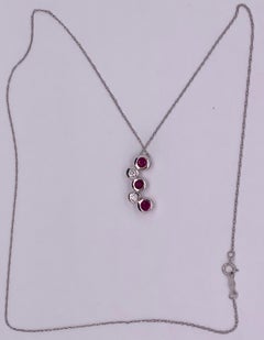 14kt Gold Ruby and Diamond Necklace Having 3 Rubies and 2 Round Diamonds