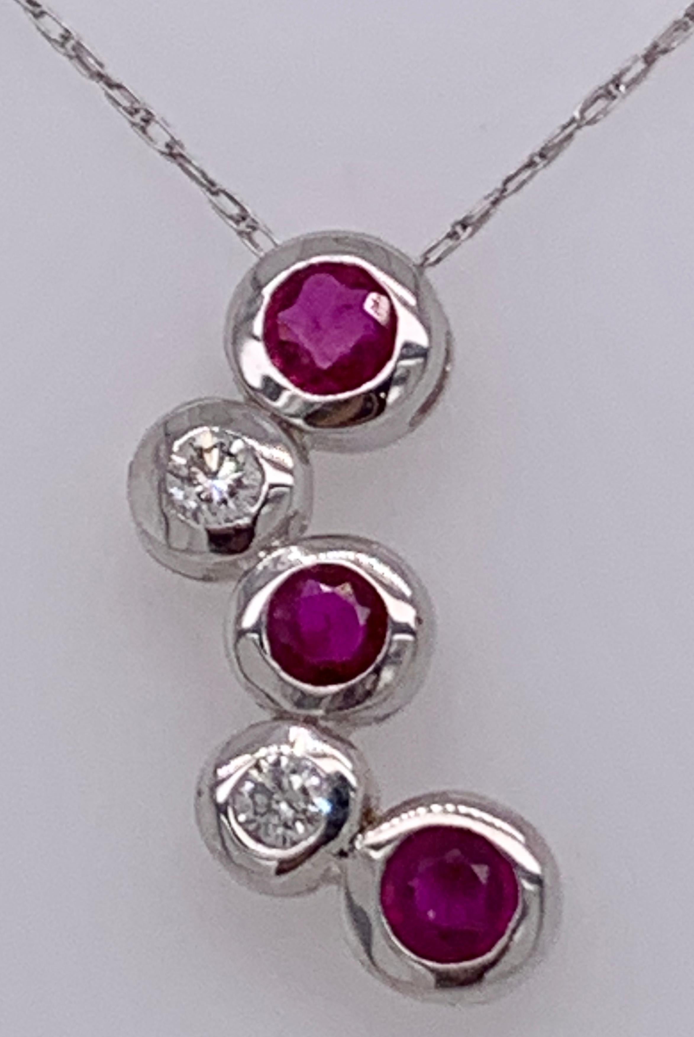 14kt Gold Ruby and Diamond Necklace Having 3 Rubies and 2 Round Diamonds In Good Condition For Sale In Stamford, CT