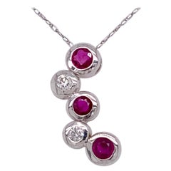 14kt Gold Ruby and Diamond Necklace Having 3 Rubies and 2 Round Diamonds