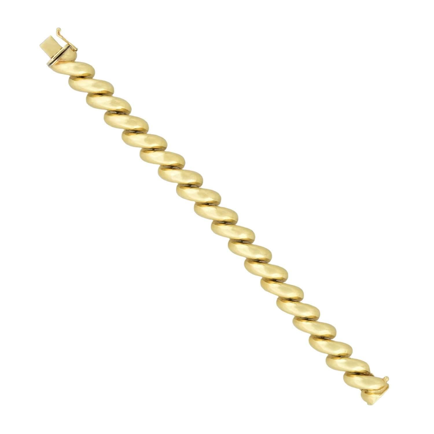 Crafted in 14kt yellow gold, this San Marco link bracelet features polished, curved links that attach at their centers, creating a flexible design. The design is mostly seamless, closed at a push clasp marked 
