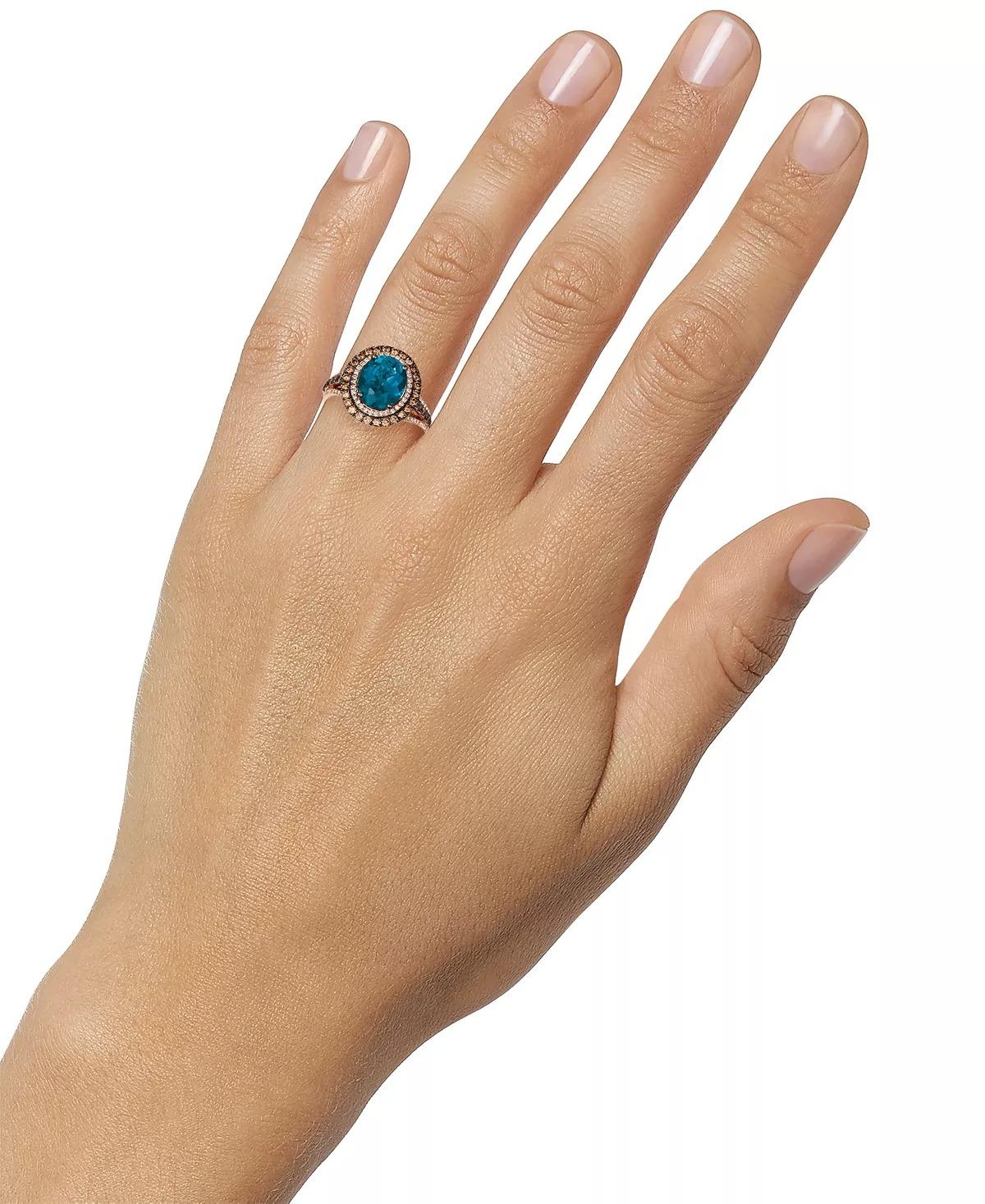 Le Vian Blue Topaz and Diamond Ring set in pink gold
Deep Sea Blue or London Blue Color Topaz is one of the finest colors.
The estimated weight of the center, oval blue topaz stone is 4 carats.
The diamond weight of the ring is .90 carat, estimated
