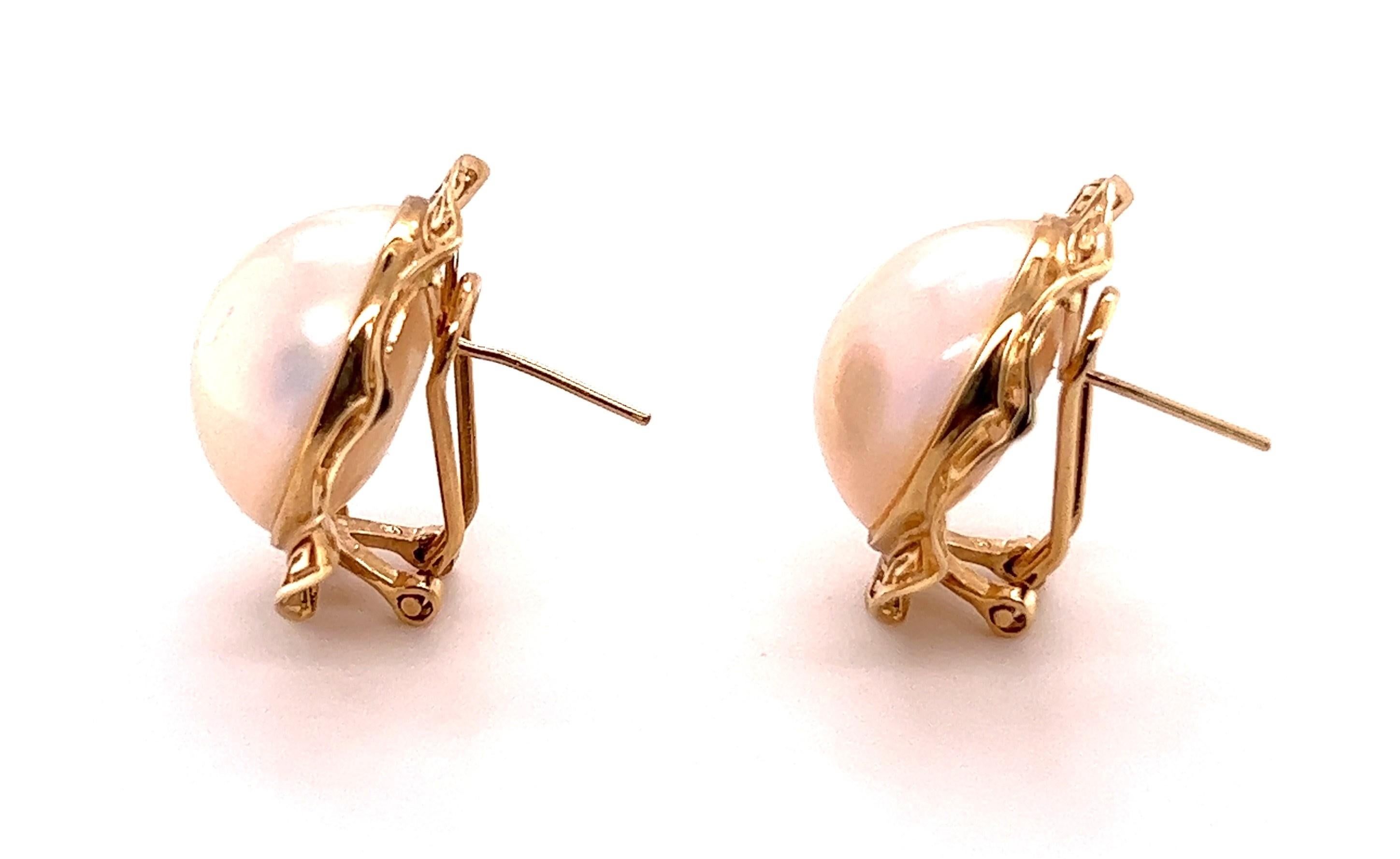 The classic styles of the 80s are back and here to stay! And can you blame them- they're classic and cool! Be classic and cool when you sport these earrings. 

These button style earrings feature a mabe' pearl in the center that measures about 5/8