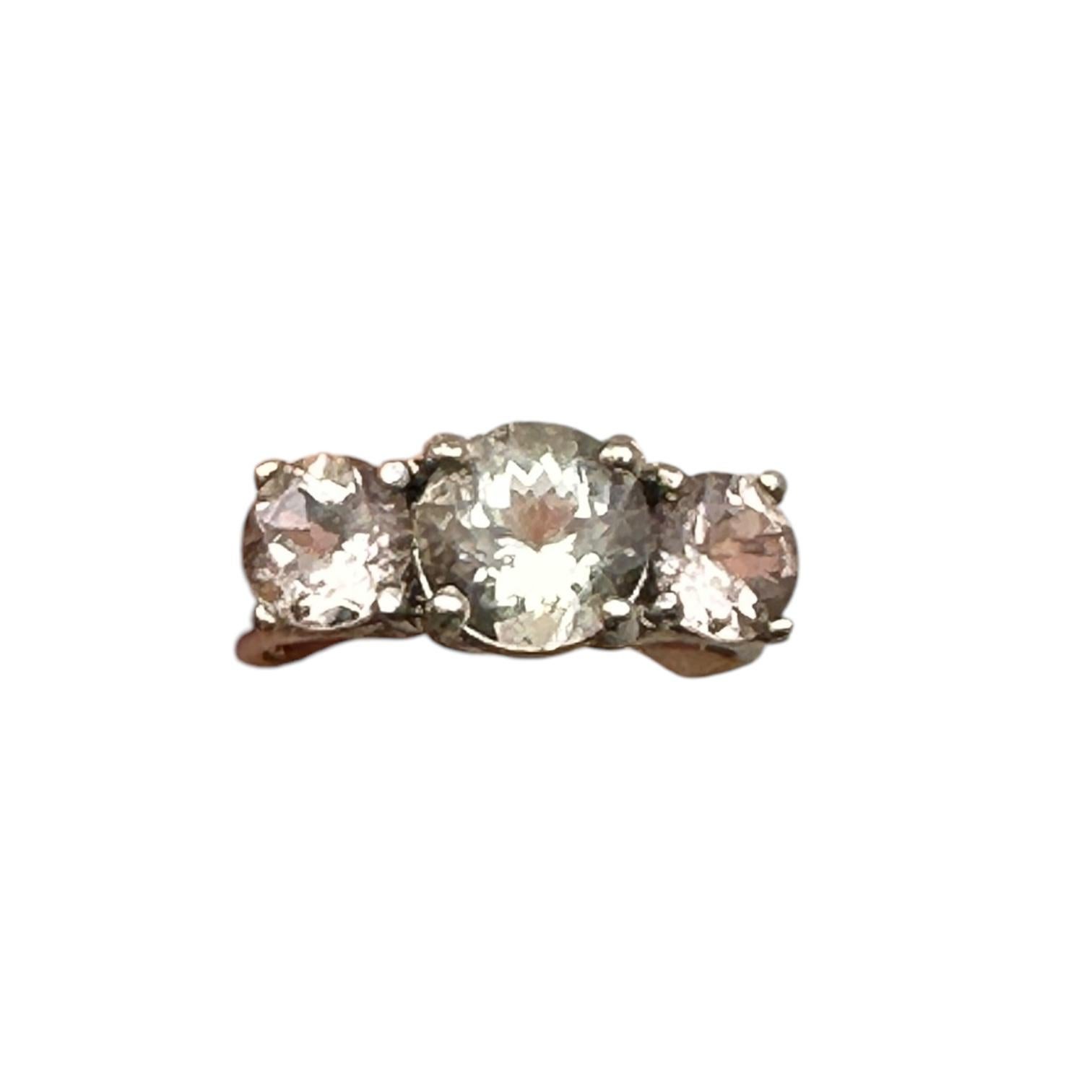 The stunning, blush-colored gemstones are set in 14-karat white gold.  The morganite and prasiolite (green amethyst) ring showcase a timeless design with a modern twist. Featuring three stunning gemstones, this past-present-future ring symbolizes