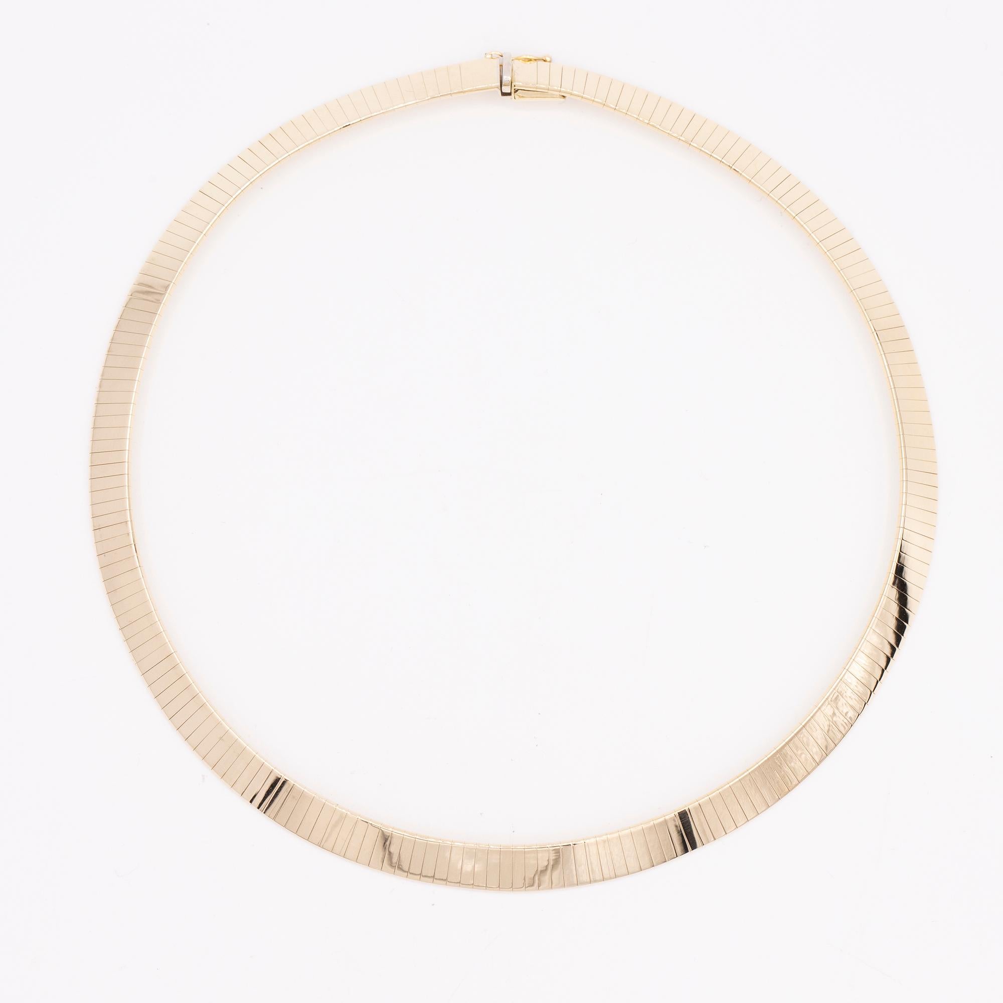 14kt yellow gold Omega flat necklace. The necklace is 8mm in width and 16
