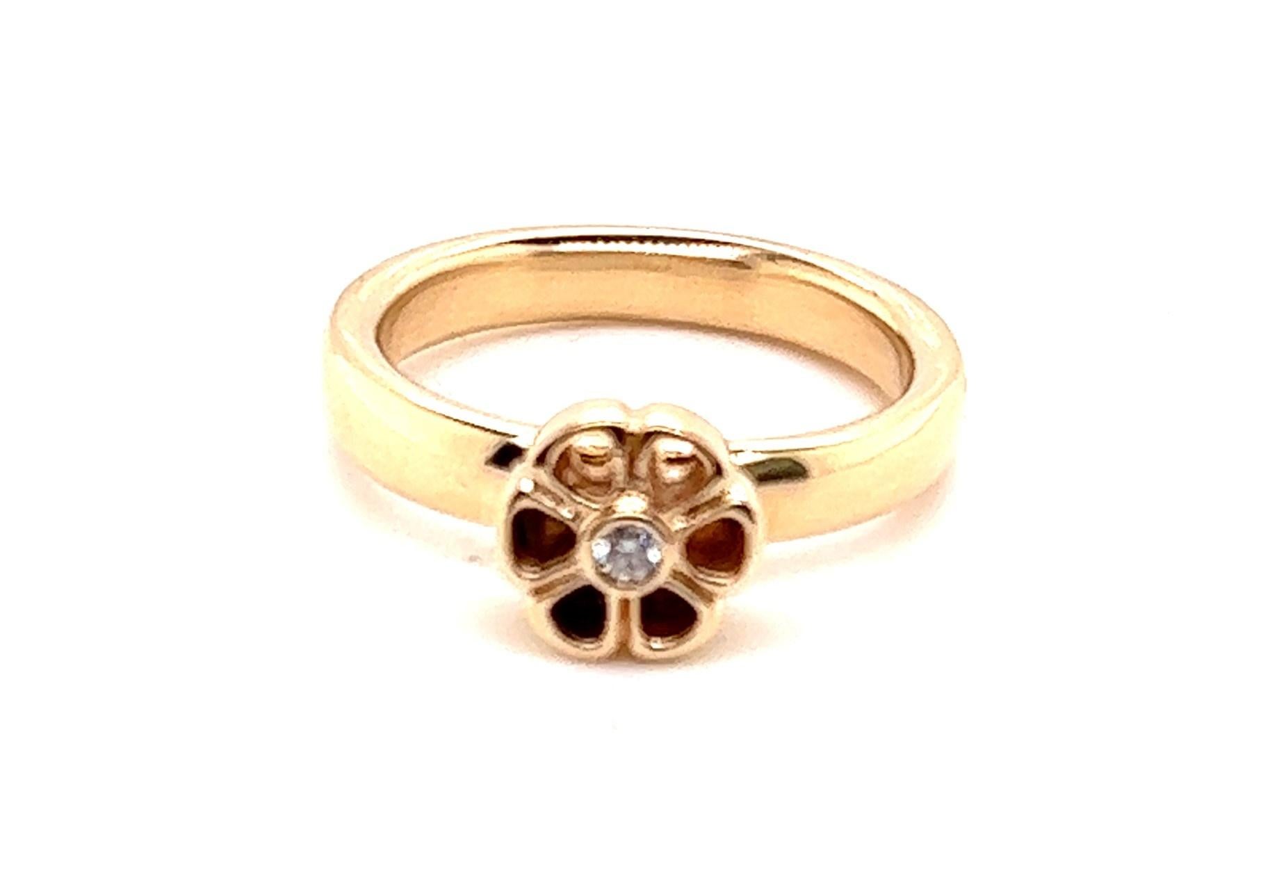 14KT YG PANDORA FLOWER RING WITH .05CT G-H/VS2-SI1 DIAMOND. 
The petals of the flower are open and will show through whatever is behind it. There are 3 photos showing the petals and how they look in different backgrounds. 

The band is wide and