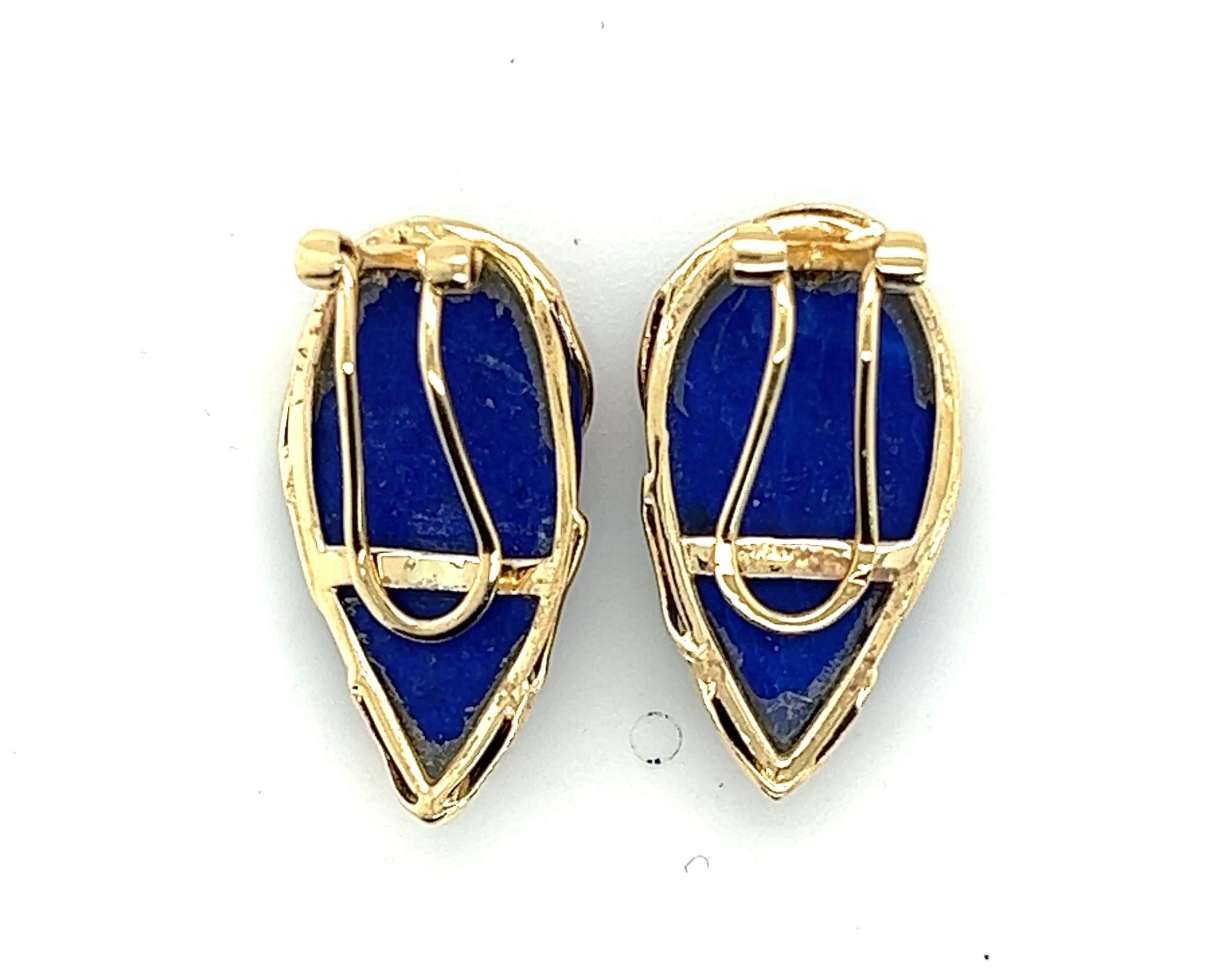 14kt yellow gold lapis lazuli earrings cut to pear shaped cabochons. The earrings wrap gold around the front of the stones for a sleek and refined look (and to add to the sparkle of the gold colored flecks in the lapis). These clip on earrings have