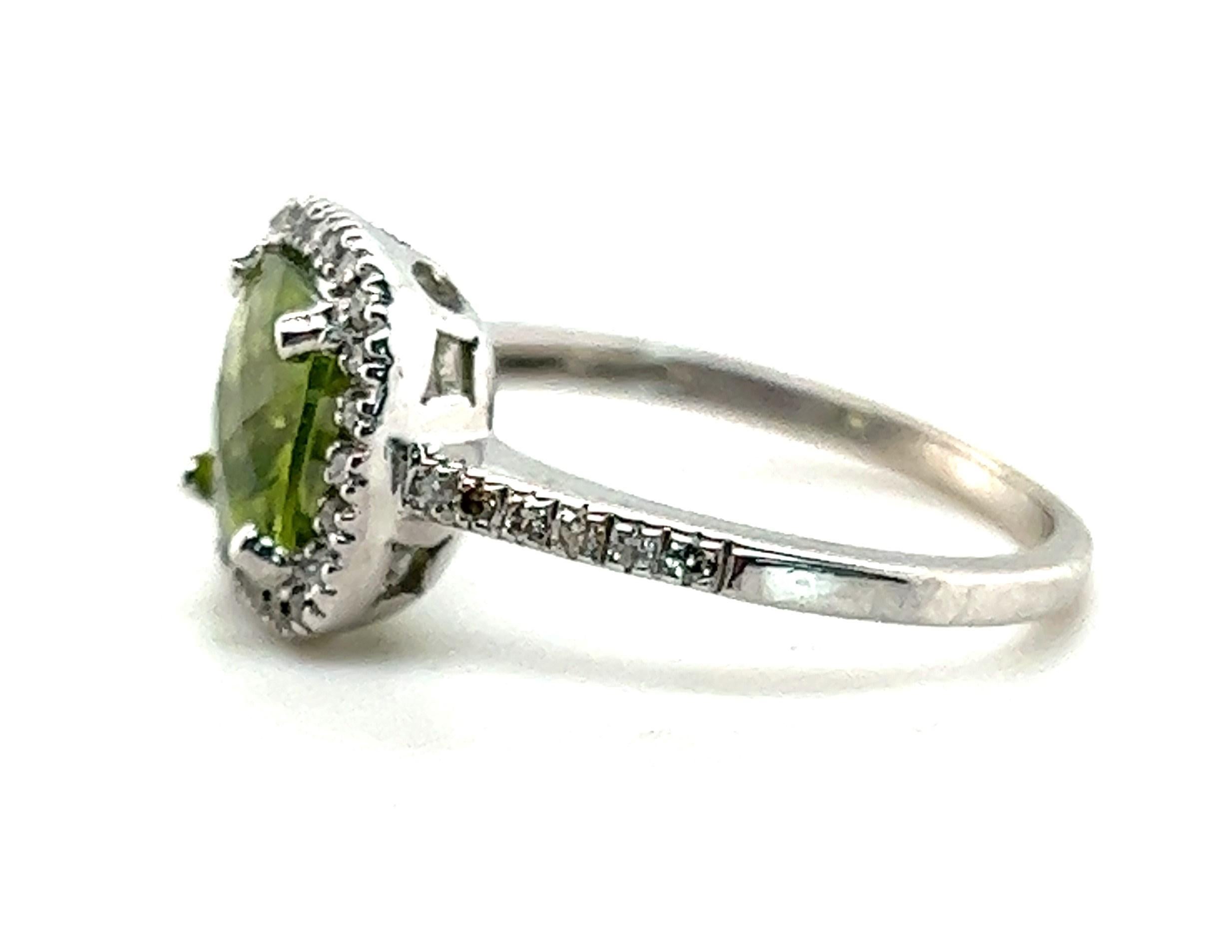 What do you get the August baby with everything? This gorgeous peridot ring, of course!

This ring contains one center antique cushion cut peridot weighing approximately 1.59 carats. Surrounding the peridot is a halo of diamonds weighing