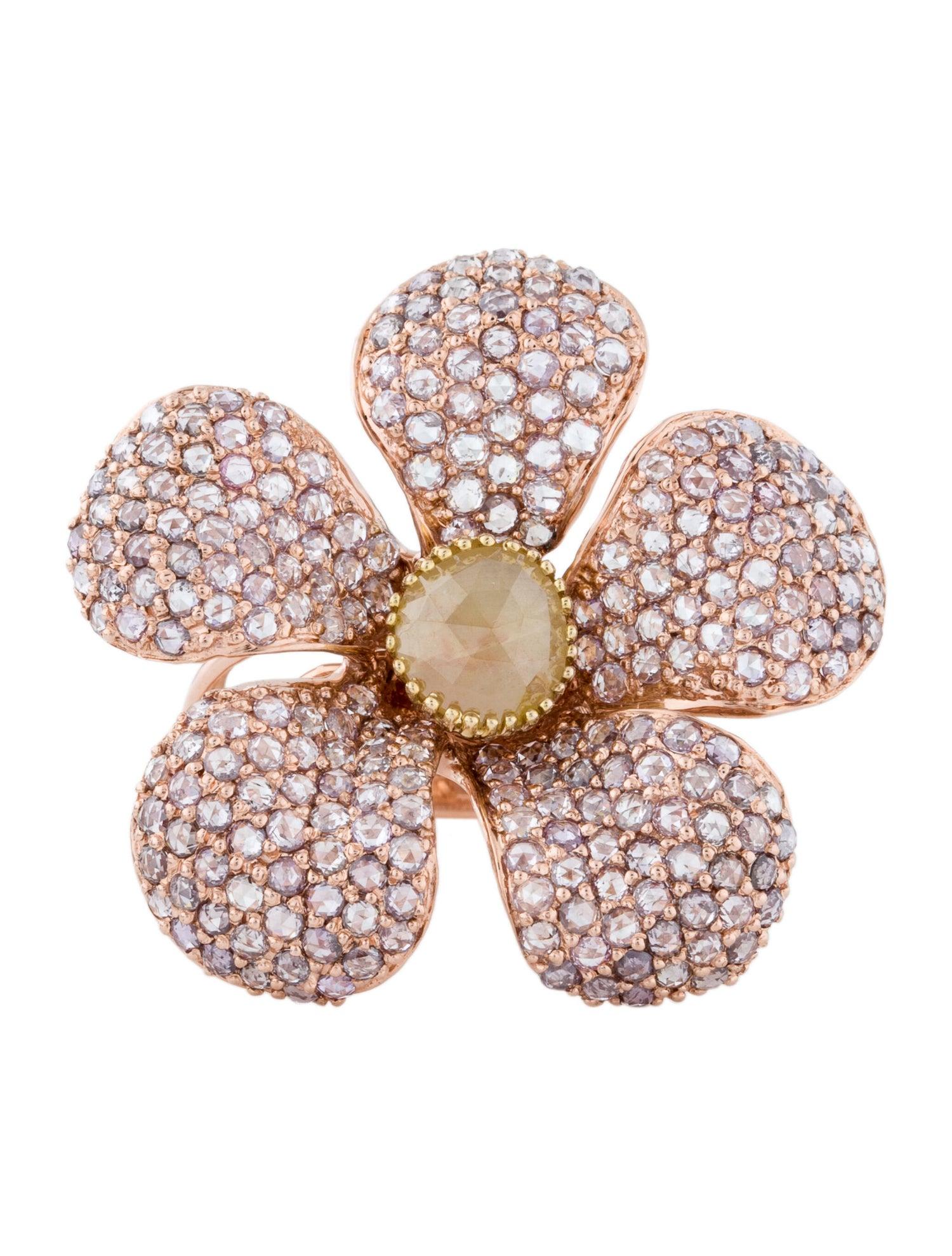 A beautiful 14Kt rose gold diamond ring featuring Fancy Pink Rose cut diamonds throughout and an oval rose cut yellow diamond at center. Some of the fancy colored stones are treated to enhance the color. There are 250 pink rose cut diamonds set in