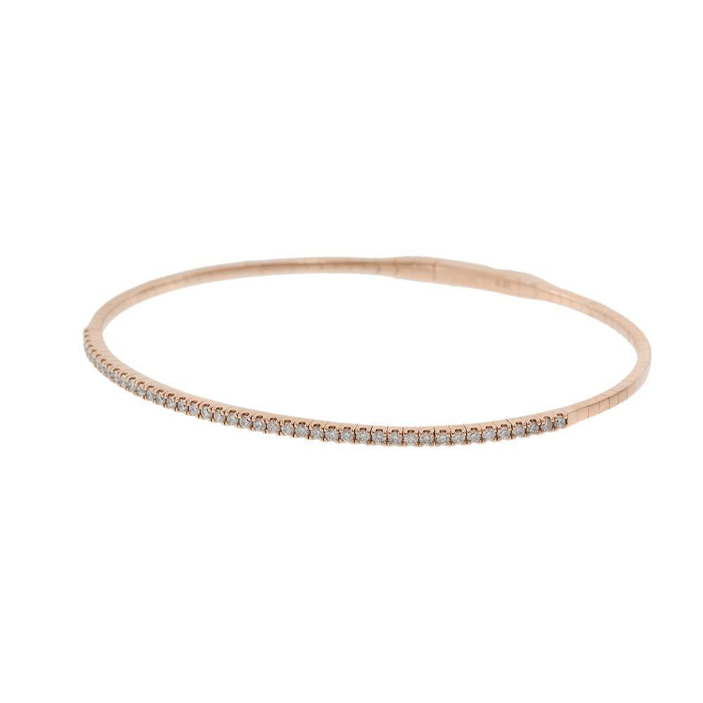 This elegant and minimalist flex bangle is crafted in 14KT rose gold and showcases a single row of dazzling round brilliant cut diamonds totaling 0.50 carats. The flexible design allows for comfortable wear and a sleek, secure fit, making it a