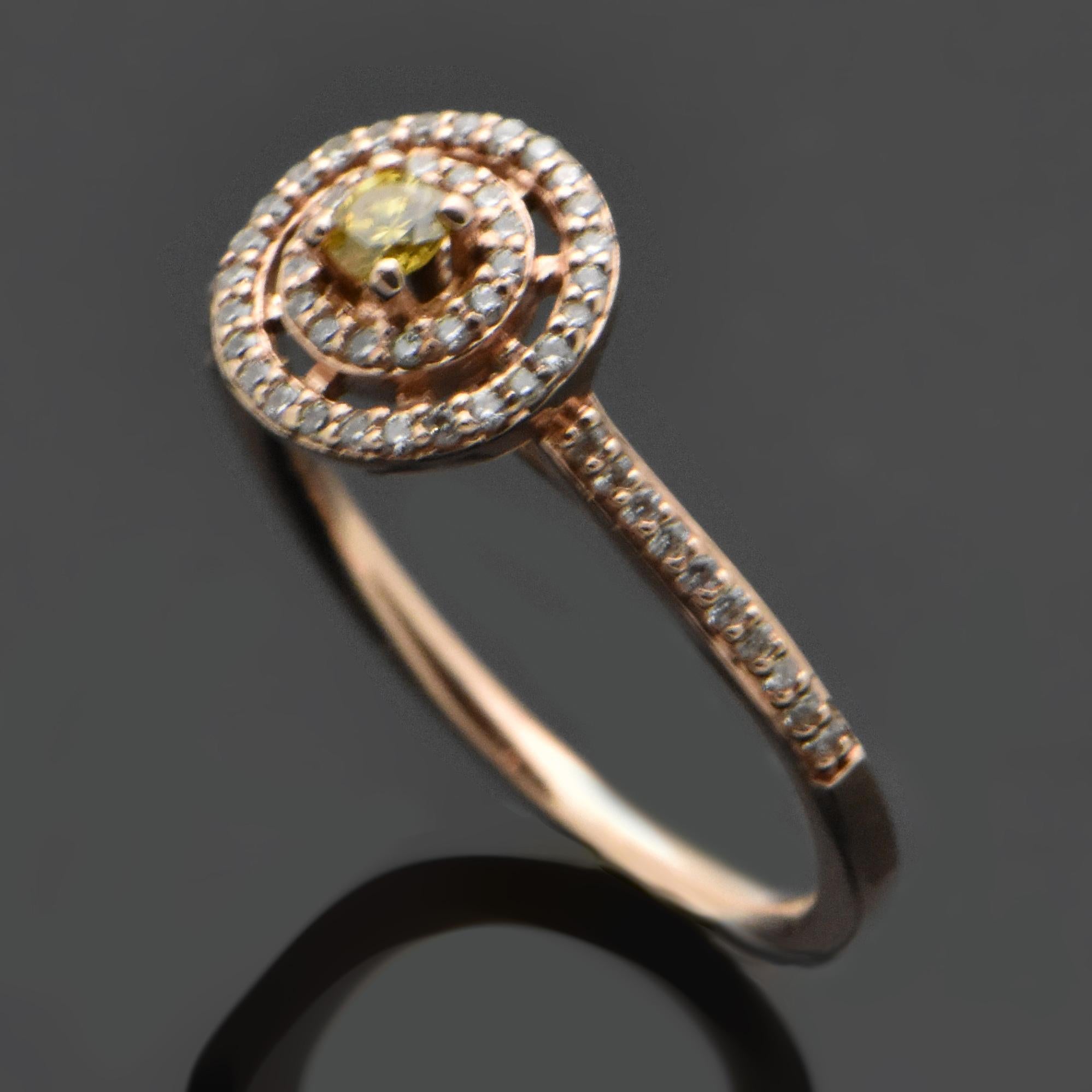 A 14kt rose gold ring with a yellow diamond estimated at 0.08ct. The setting also features a double halo and diamonds down the shank estimated at 0.22cttw. Estimated weight of gold is 2 gr. 

We will size it for you.

