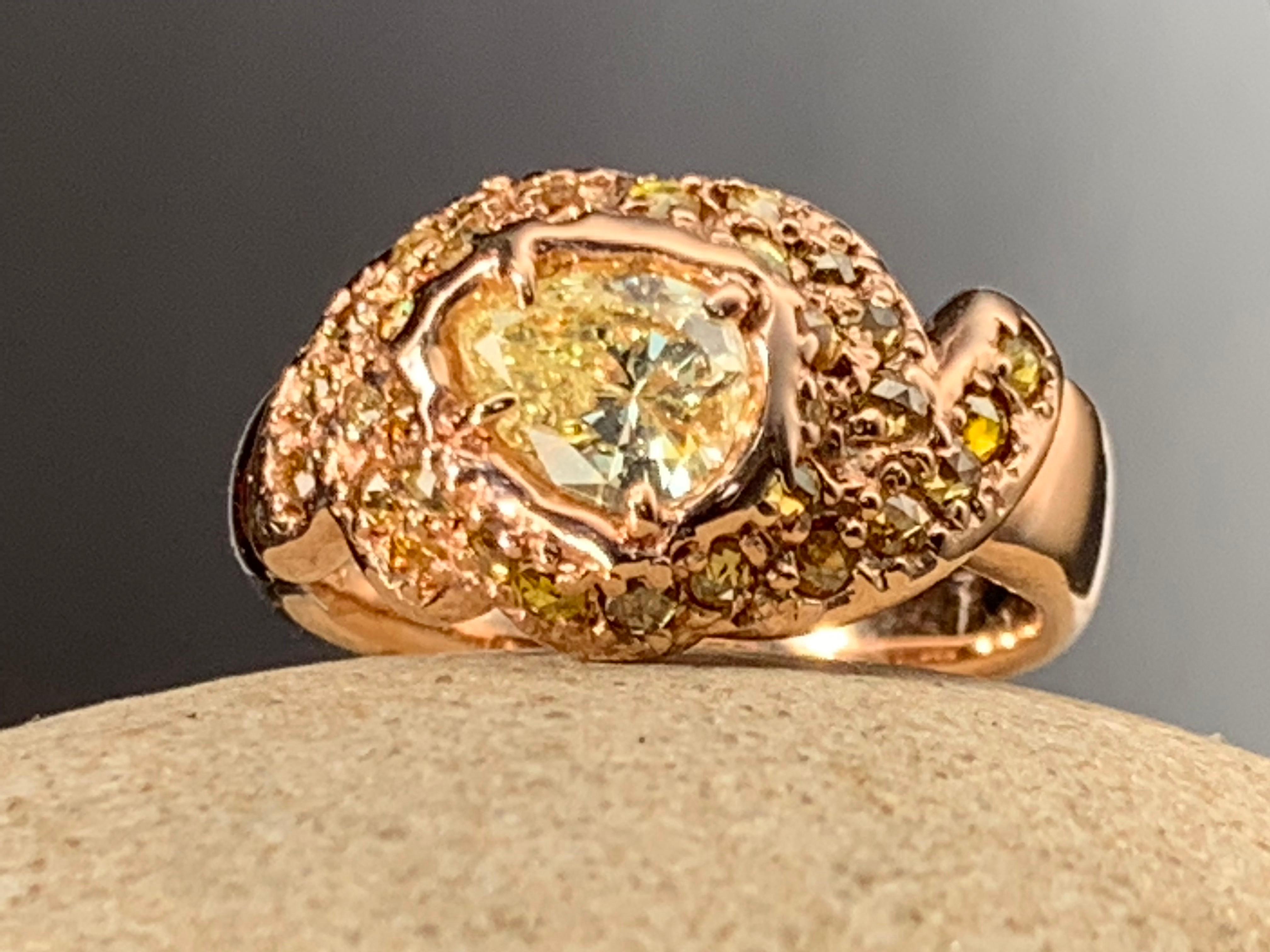 The one-of-a-kind organically sculpted Phoenix Flame ring is both a unique and a rich color experience. The gemmy yellow rose cut diamonds are of various hues and sparkle from all directions. The center yellow pear shape diamond is highly saturated