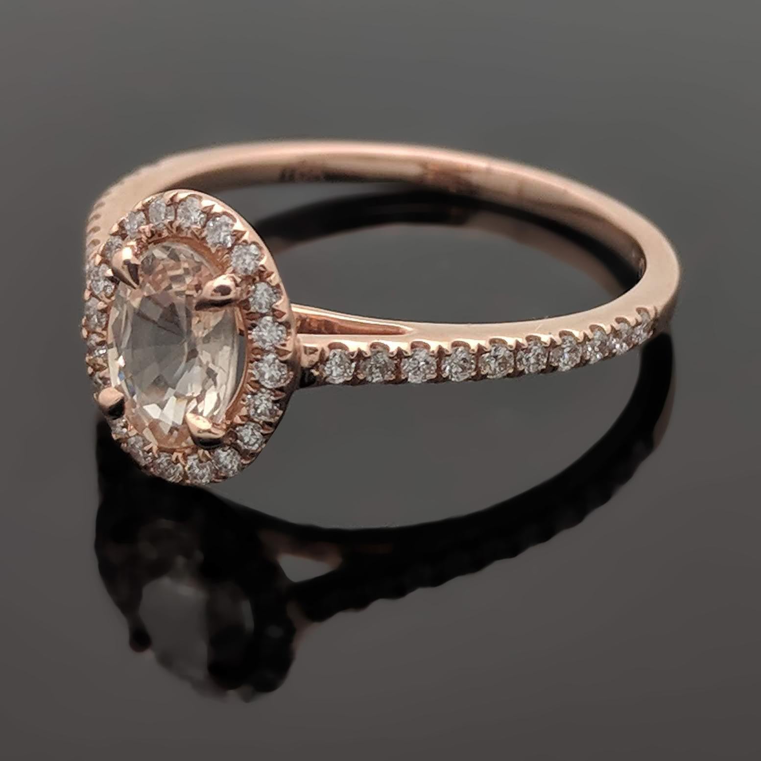 This 14kt rose gold ring features a pink sapphire estimated at 0.50ct in a 4 prong setting. The sapphire is surrounded by a diamond halo as well as diamonds down the shank with an estimated 0.14cttw. Estimated weight of gold is 1 gr. 

We will size