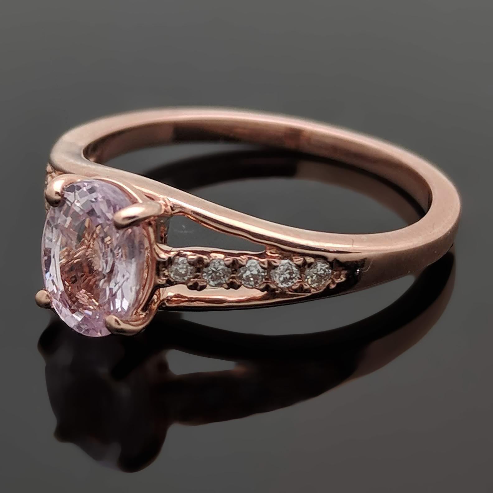 A 14kt rose gold ring featuring an oval cut pink sapphire estimated weight of 0.86ct. The sides feature a triple split band with small diamonds estimated at 0.04cttw. lining the center shank. Estimated weight of gold is 2.65 gr. 

We will size it