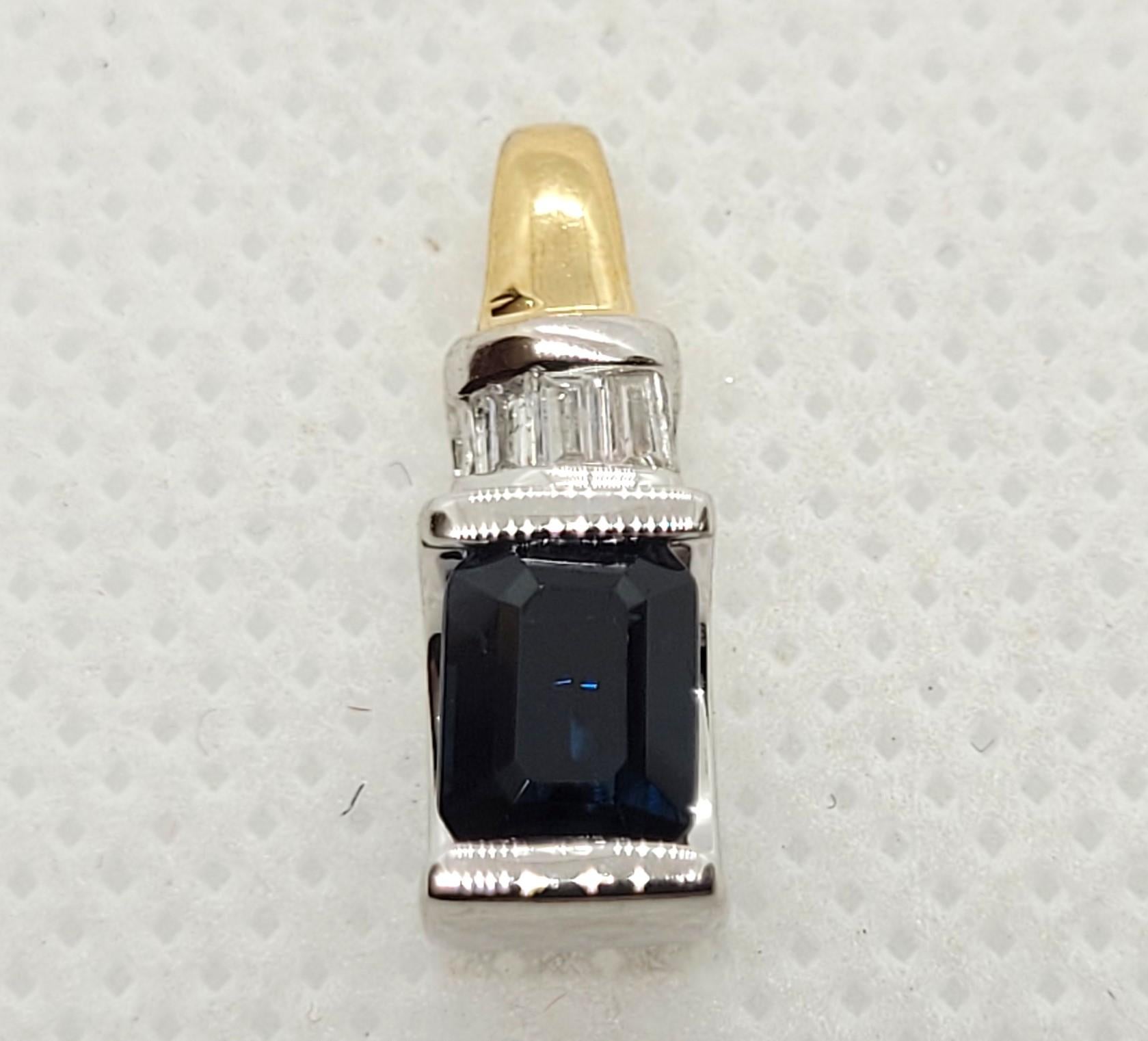 14kt Two-Tone Gold 1.00Ct Emerald Cut Sapphire .10cttw Baguette Diamond Pendant. The pendant is 18mm x 6.10mm x 6.2mm stamped 14kt, weighing 2.3 grams.  Elevate your style with this exquisite 14kt two-tone pendant featuring a stunning channel-set