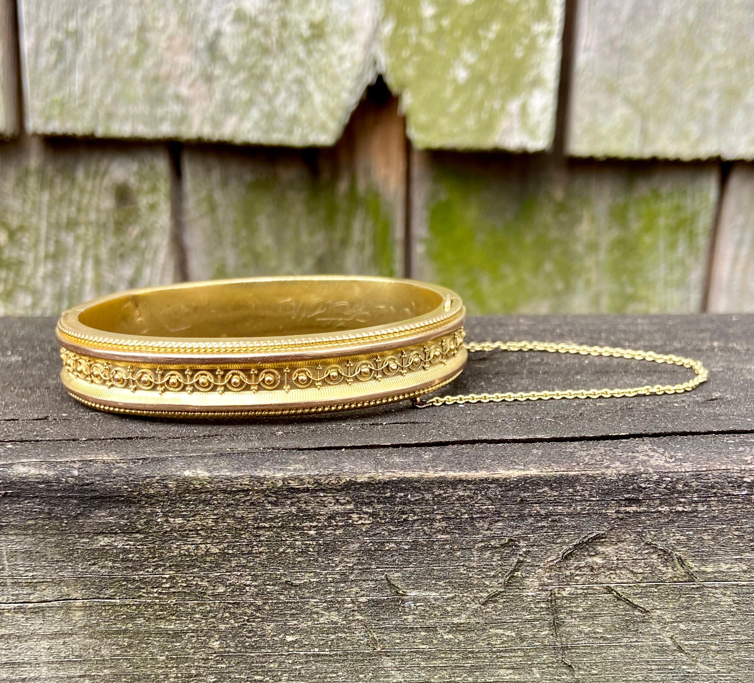 One 14 karat yellow gold Victorian bracelet measuring 2.25 inches in diameter complete with hidden closure and safety chain.  The bracelet is intended for smaller wrists.  