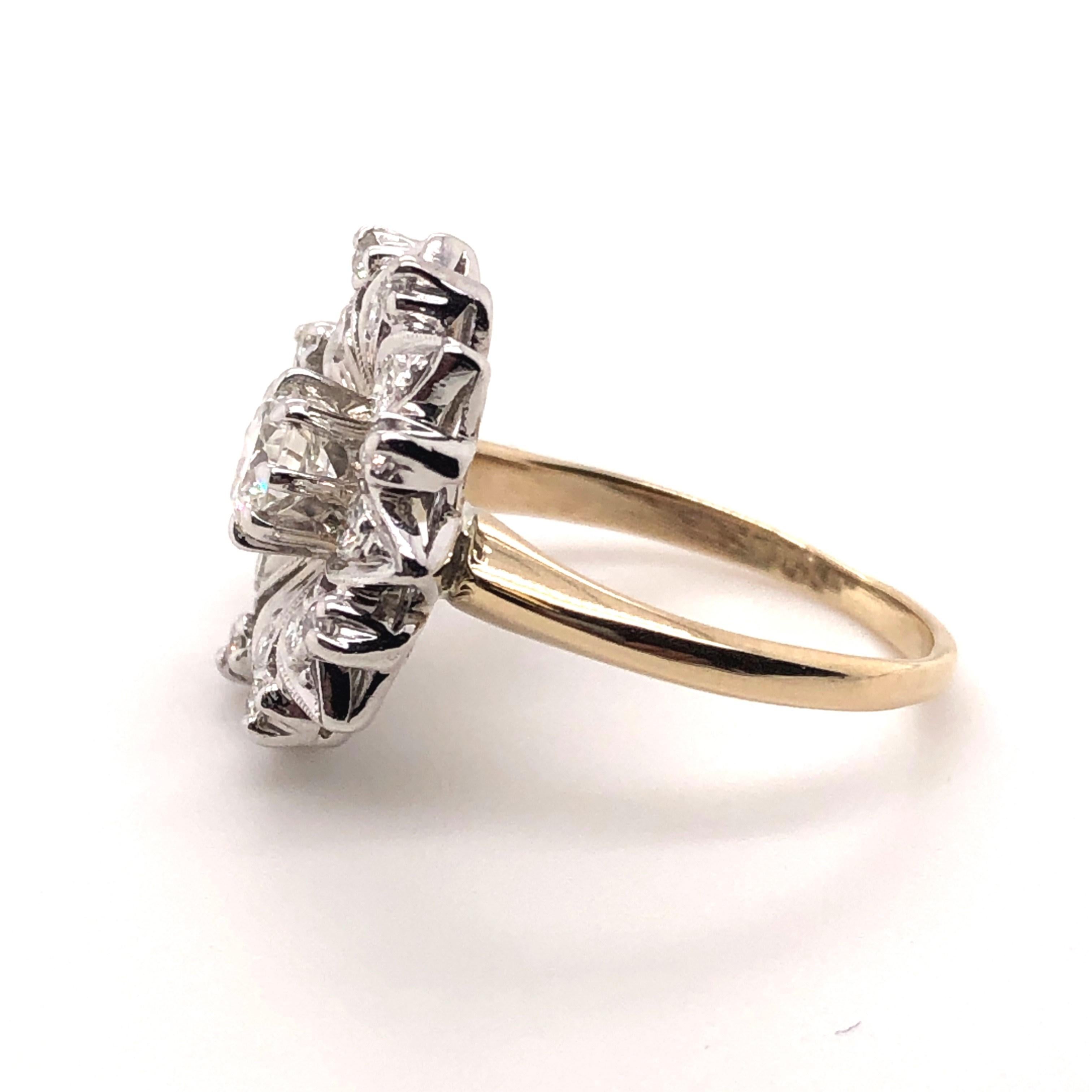 In the 1950's, the would went through a Victorian Revival. This ring is fashioned in a style made to look like similar rings from the Victorian era. This ring is crafted in white gold where the diamonds are set and a yellow gold band. The center