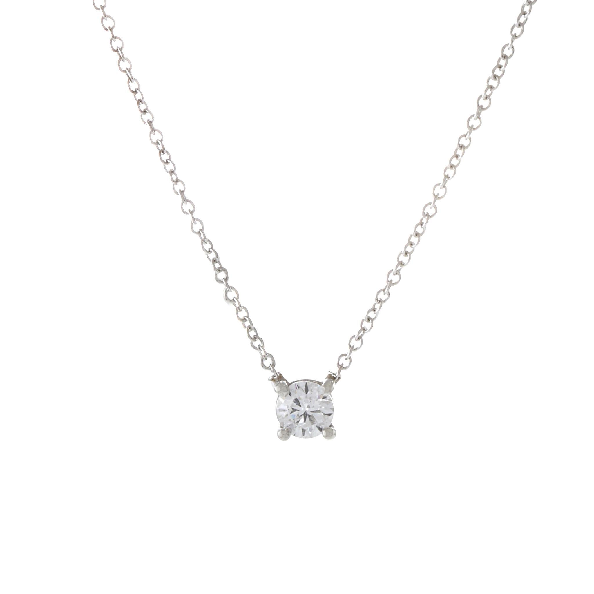 This timeless solitaire diamond necklace boasts a 0.25CT-TW round brilliant diamond with I color and SI1 clarity, elegantly set on a 14KT white gold cable chain. With its classic design and sparkling diamond, this necklace is a versatile and elegant