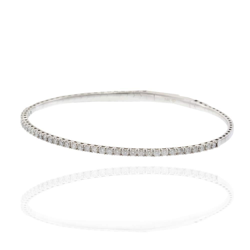 Timeless in tone and refined in design, this 14KT white gold flex bangle features a full 1.00 carat of round brilliant diamonds set in a seamless, slender row. Its flexible structure hugs the wrist with ease and elegance, offering both comfort and