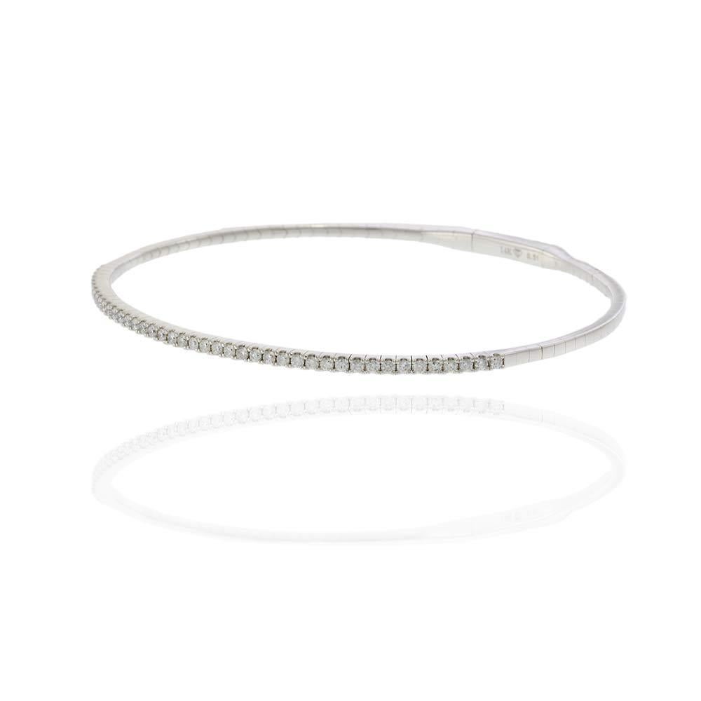 Understated and timeless, this 14KT white gold flex bangle is adorned with a single shimmering row of round brilliant diamonds totaling 0.50 carats. With a comfortable and flexible fit, this sleek bangle transitions effortlessly from day to night.