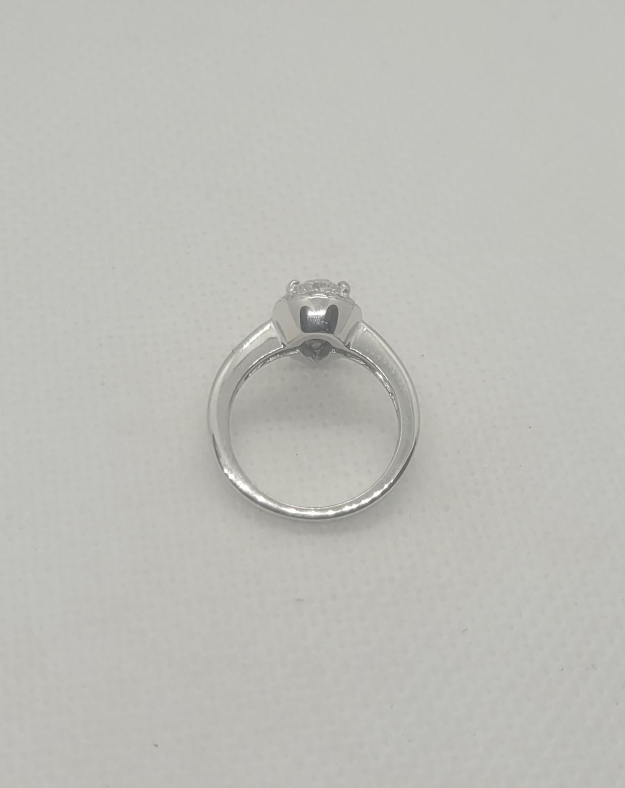 Modern 14kt White Gold .80ct Pear Cut Diamond Halo Ring, 18 Round Brilliant Diamonds For Sale
